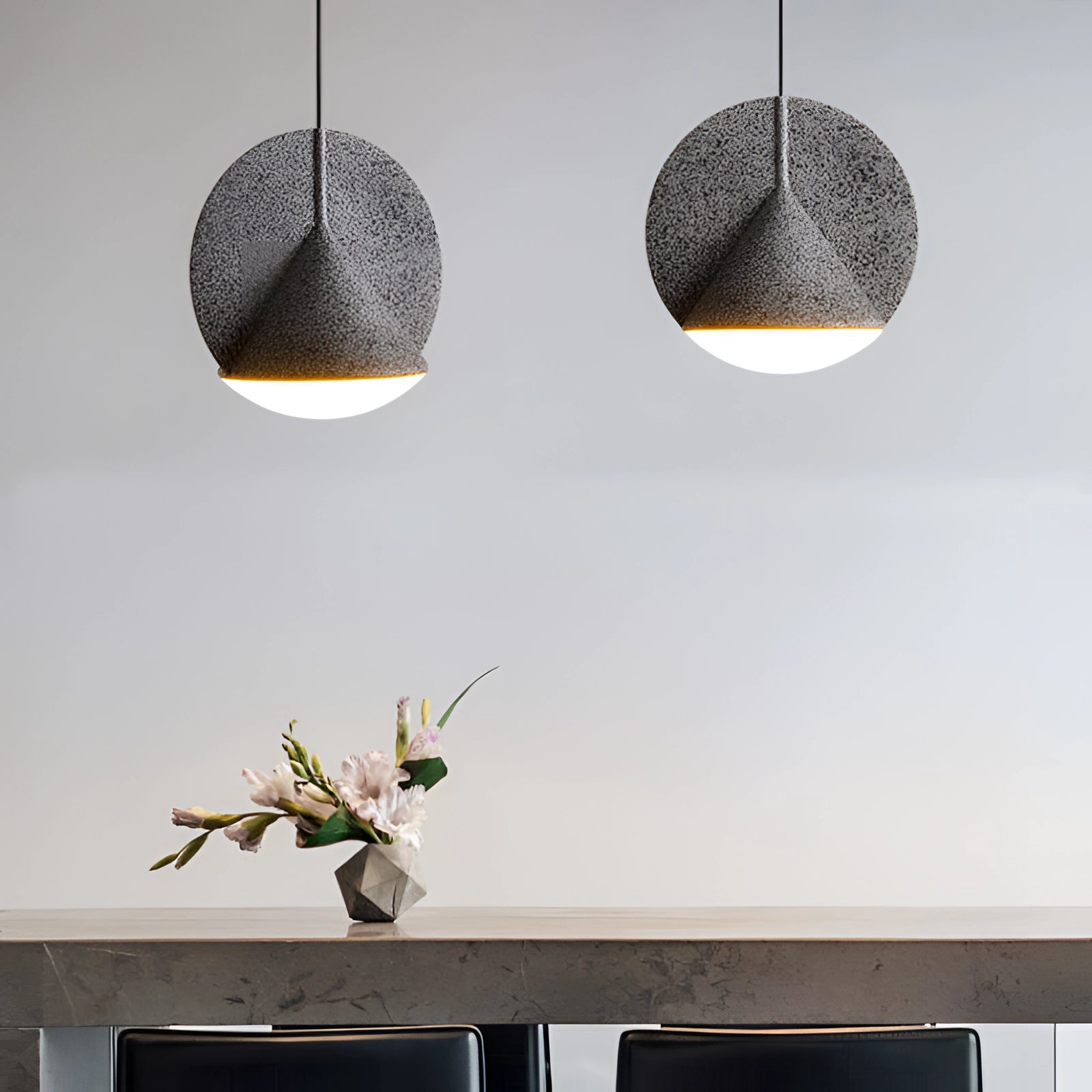 Modern colorful fabric pendant lights hanging from the ceiling with a mix of wood and metal accents, showcasing various tints and shades in a contemporary rectangular design.