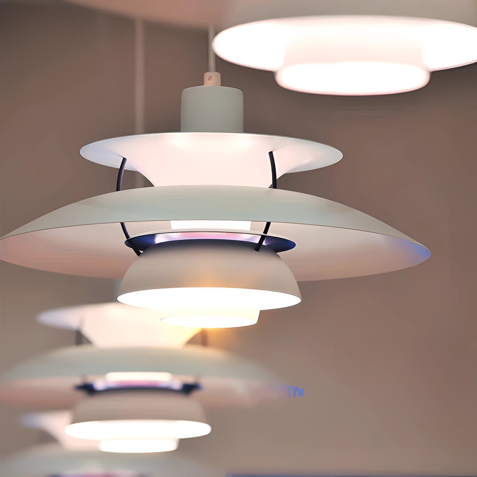 Modern colorful pendant lighting in a Scandinavian design, featuring a multi-tiered structure with circular shapes and vibrant shades, suspended from the ceiling as a stylish ceiling fixture.