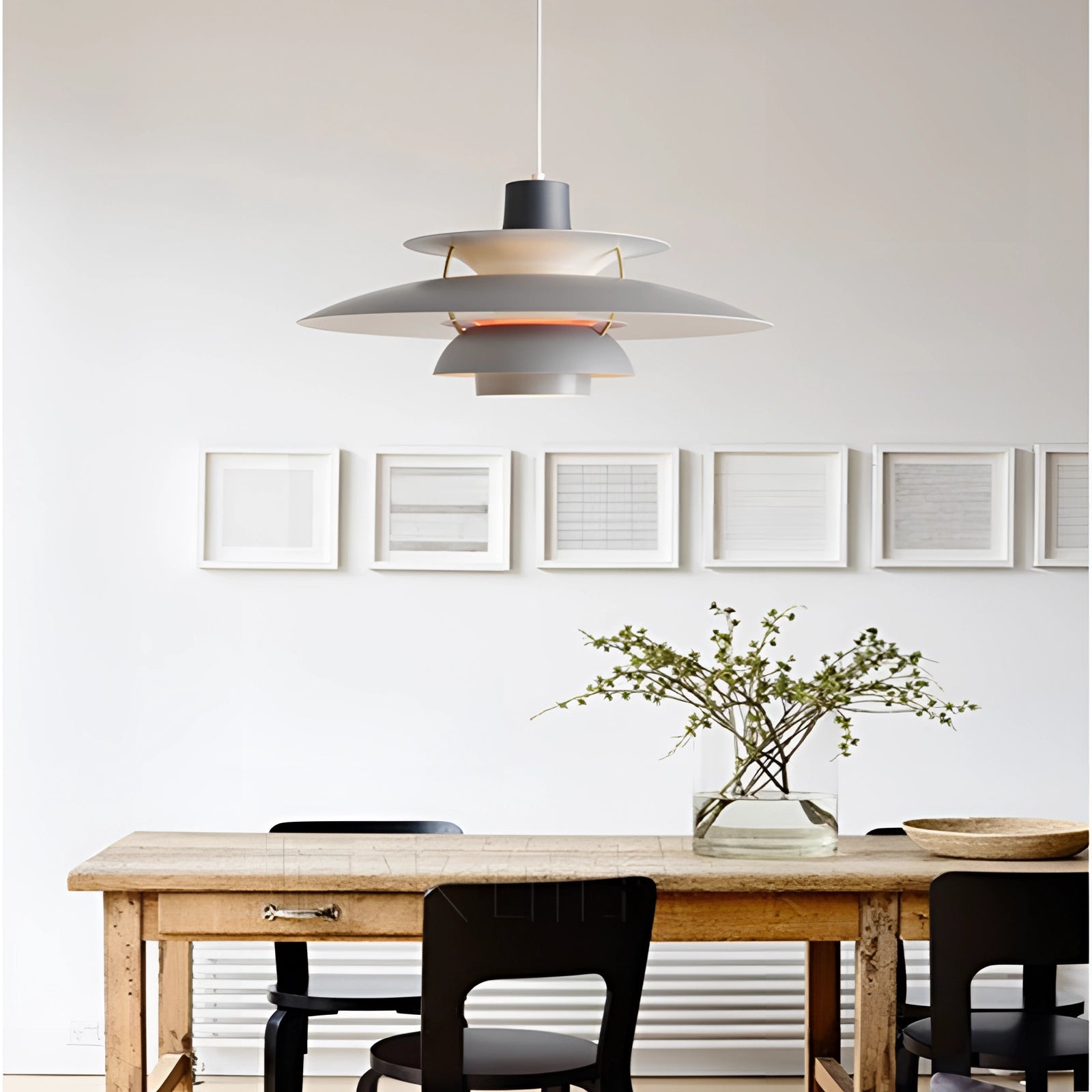 Modern colorful pendant lighting with a Scandinavian design and multi-tiered structure hanging above a wooden table in a stylish interior setting.