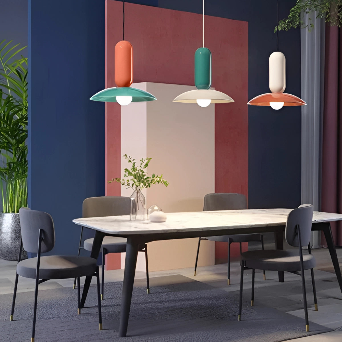 Modern colorful pendant lights hanging above a wooden dining table, surrounded by contemporary Scandinavian interior elements, including sleek chairs and a potted plant, creating a stylish kitchen and dining space.