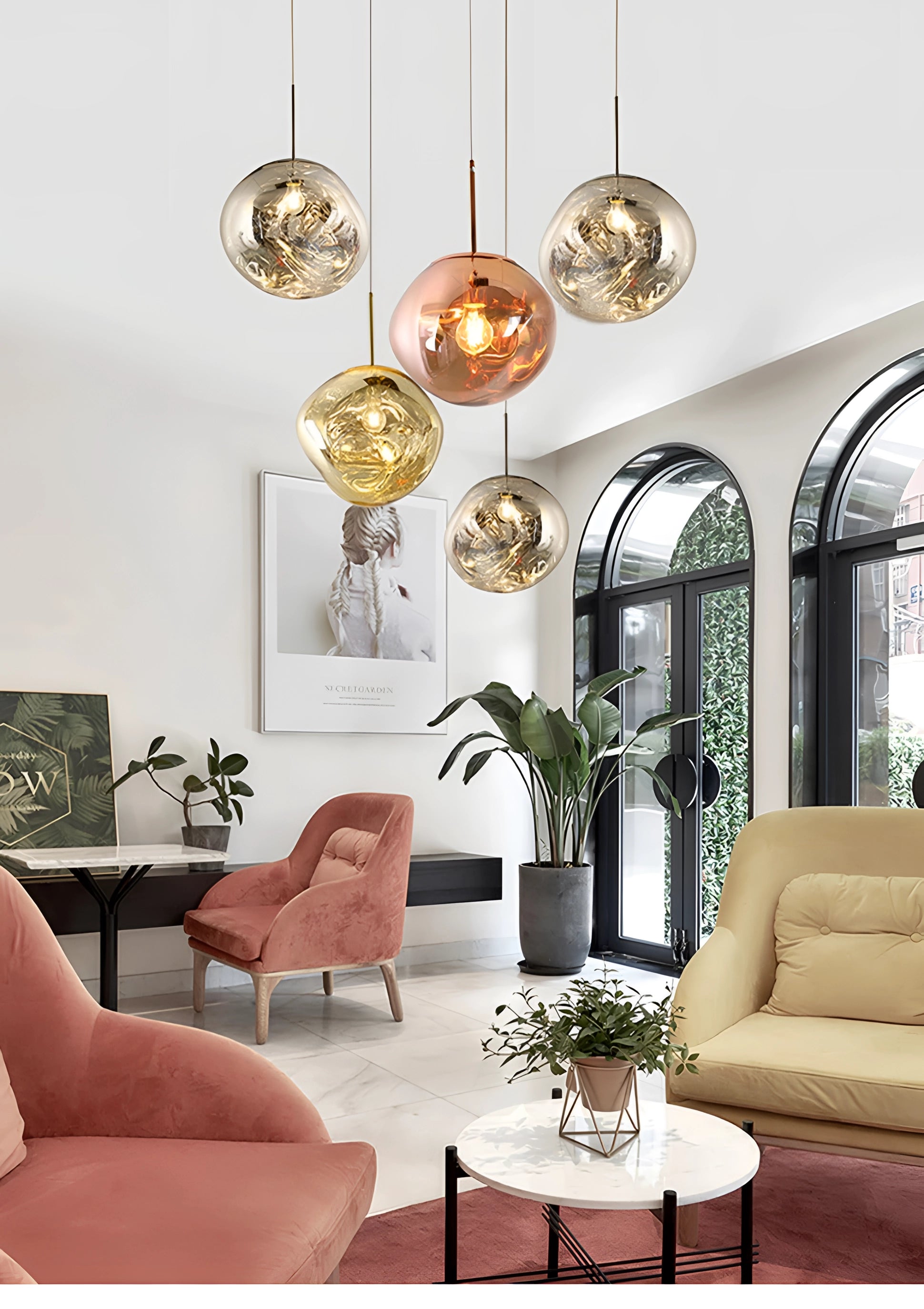 Modern copper LED pendant lights illuminating a stylishly furnished interior with a comfortable couch, wooden table, and decorative plants, embodying contemporary design.