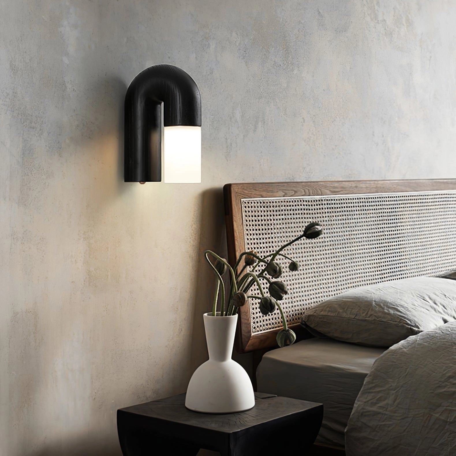 Modern curved wooden wall sconce with a minimalist arch design featuring LED lighting, set against a sleek black and grey interior with subtle wooden accents.