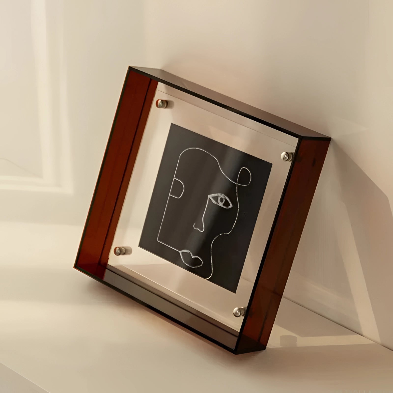 
A modern decorative acrylic color block sculpture featuring a sleek rectangular design with shades of brown, measuring 21cm x 16cm, displayed on a wooden surface.
