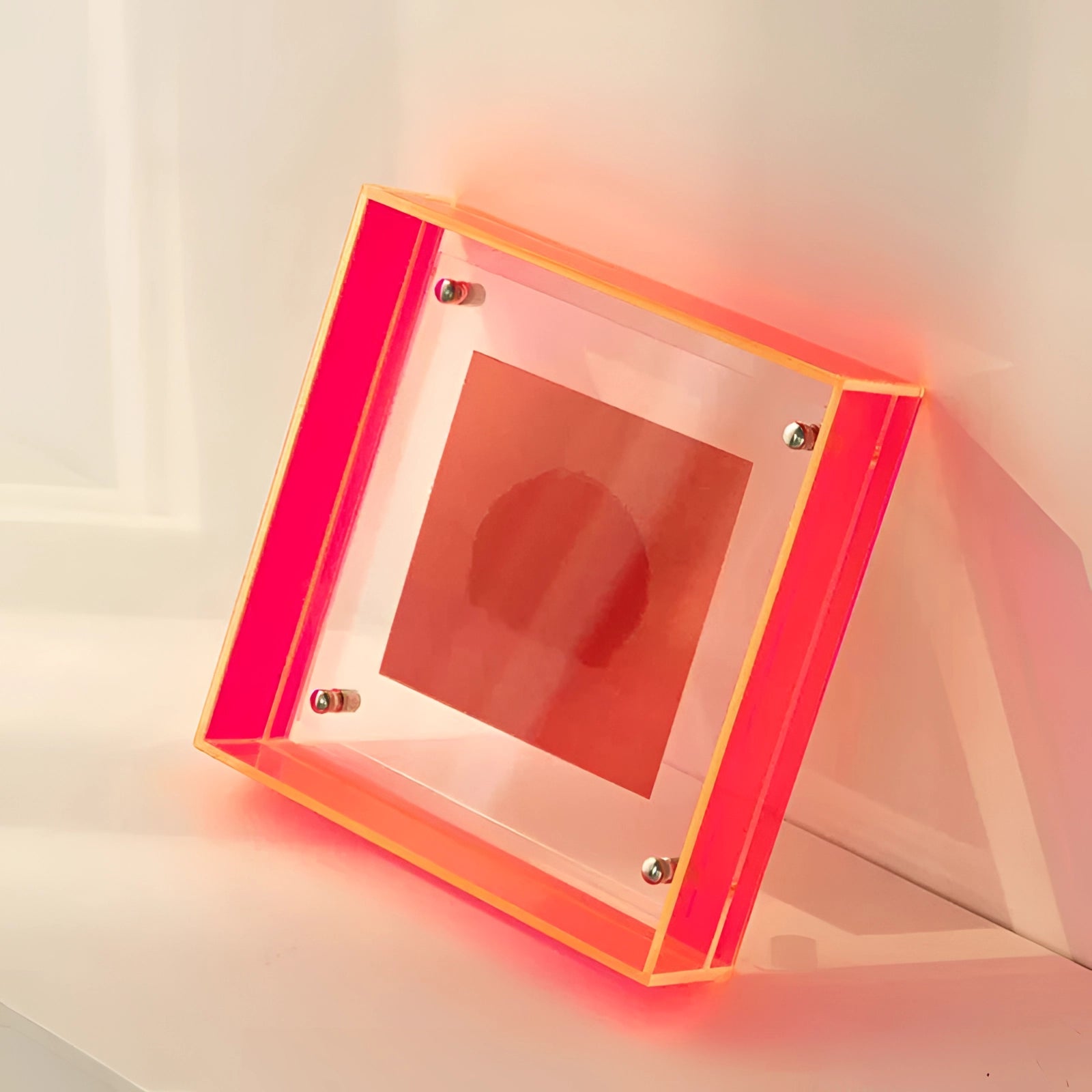 Modern decorative acrylic color block sculpture in bright red, rectangular shape, measuring 21cm by 16cm, with a glossy finish that reflects light and showcases a luxurious art piece.