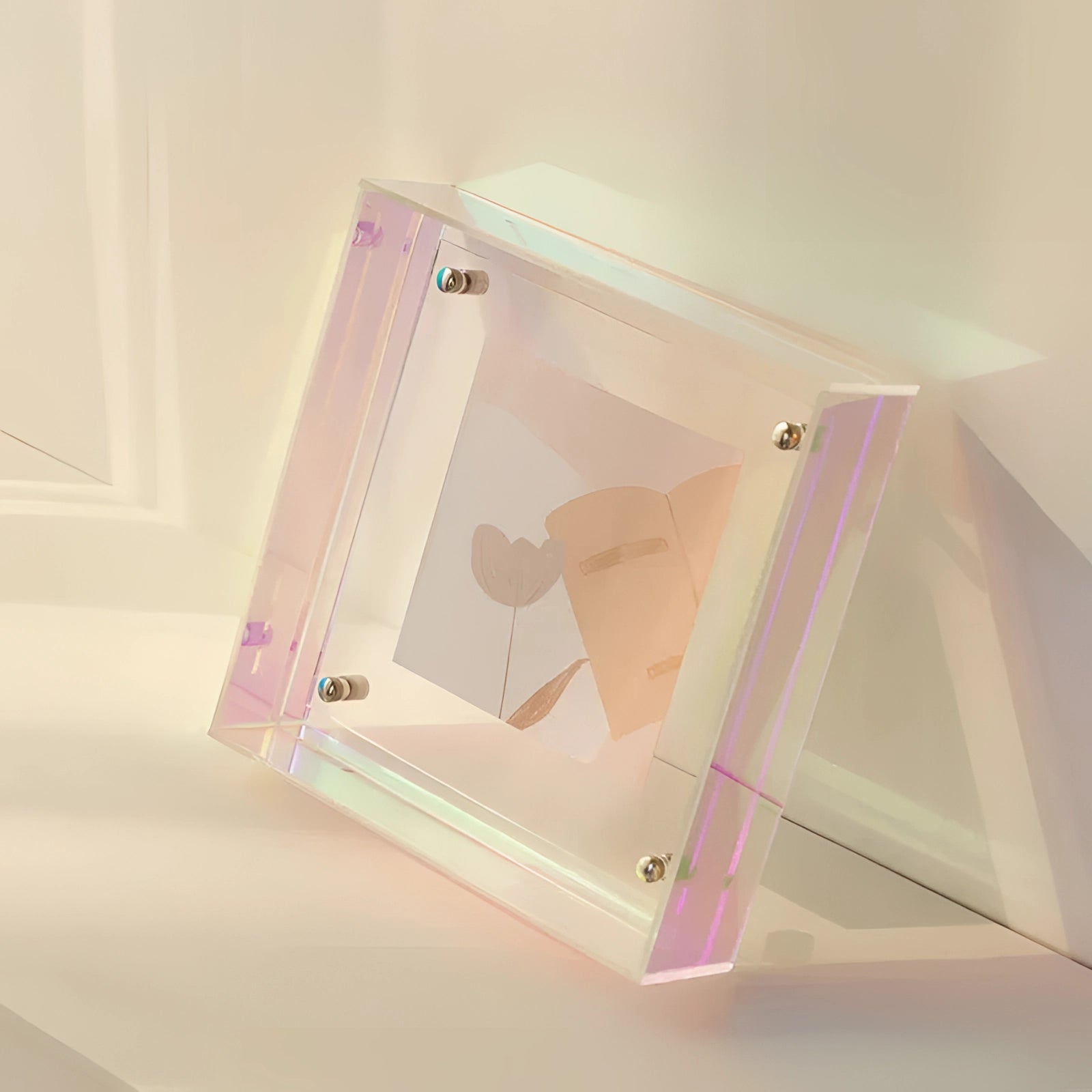 Modern decorative acrylic sculpture with a color block design in pale pink hues, measuring 21cm x 16cm. The piece features a sleek, rectangular shape with luxurious art appeal, set against a soft beige and magenta palette, adding an elegant touch to any space.