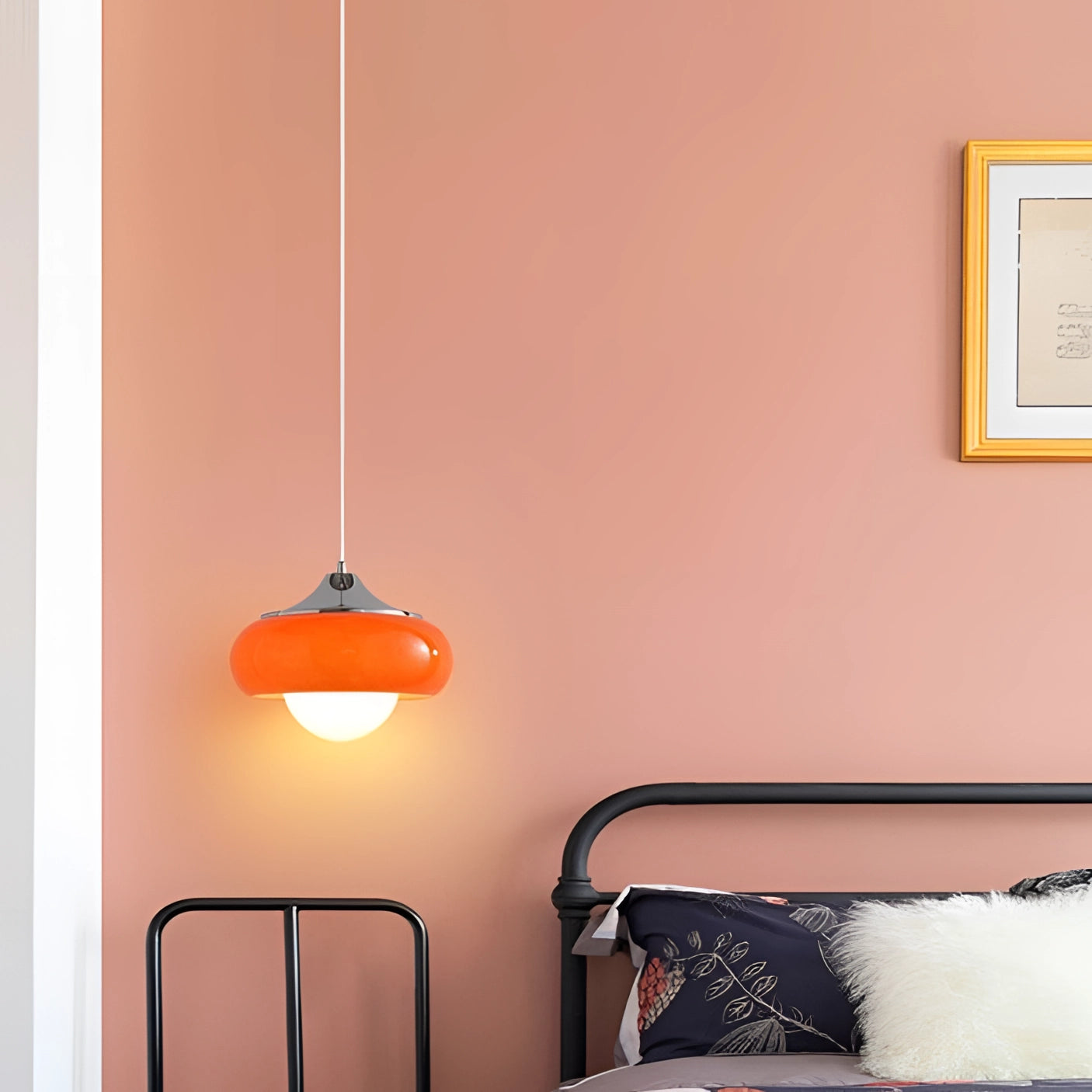 Modern dual color pendant lamps with a Scandinavian mid-century style hanging from the ceiling in a stylishly designed interior space featuring wooden elements and a warm orange tone.