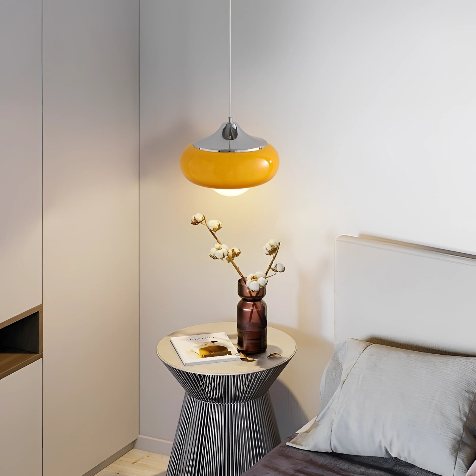 Modern dual color pendant lamps in Scandinavian mid-century style hanging above a wooden table, featuring a sleek grey design with a minimalist aesthetic, complementing the interior design with natural materials.