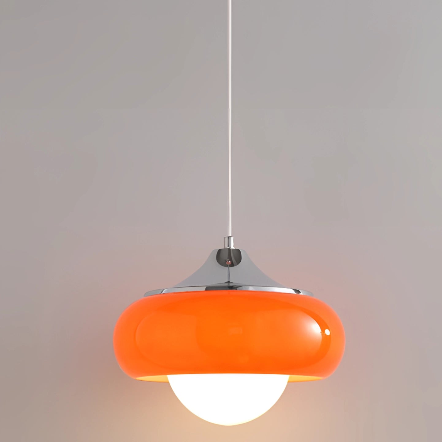 Modern dual color pendant lamp in vermillion and peach tones, featuring a Scandinavian mid-century style design. The lamp has a circular shape and is made from composite materials, hanging from the ceiling as a stylish light fixture.