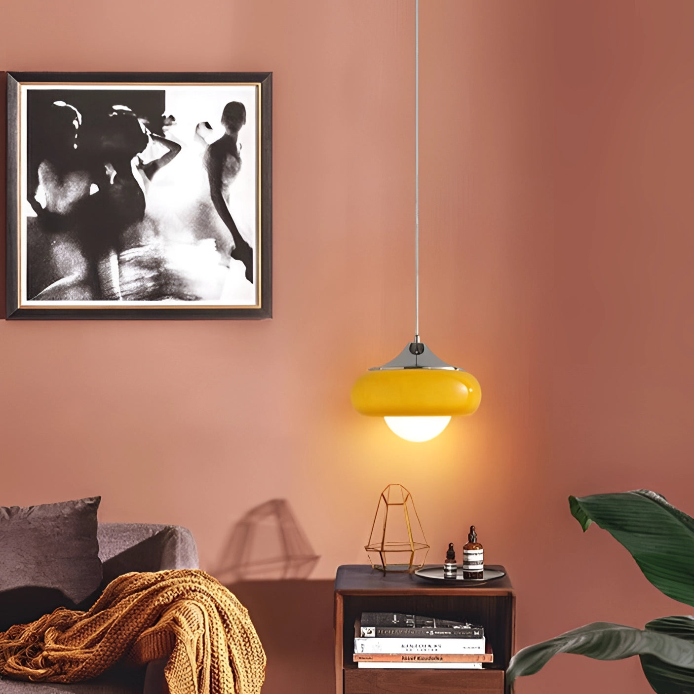 Modern dual color pendant lamps in a Scandinavian mid-century style, with a sleek wooden finish, elegantly illuminating a stylish interior. The setting includes wall accents, a framed picture, and a small plant on a nearby table, creating a cozy and inviting atmosphere.