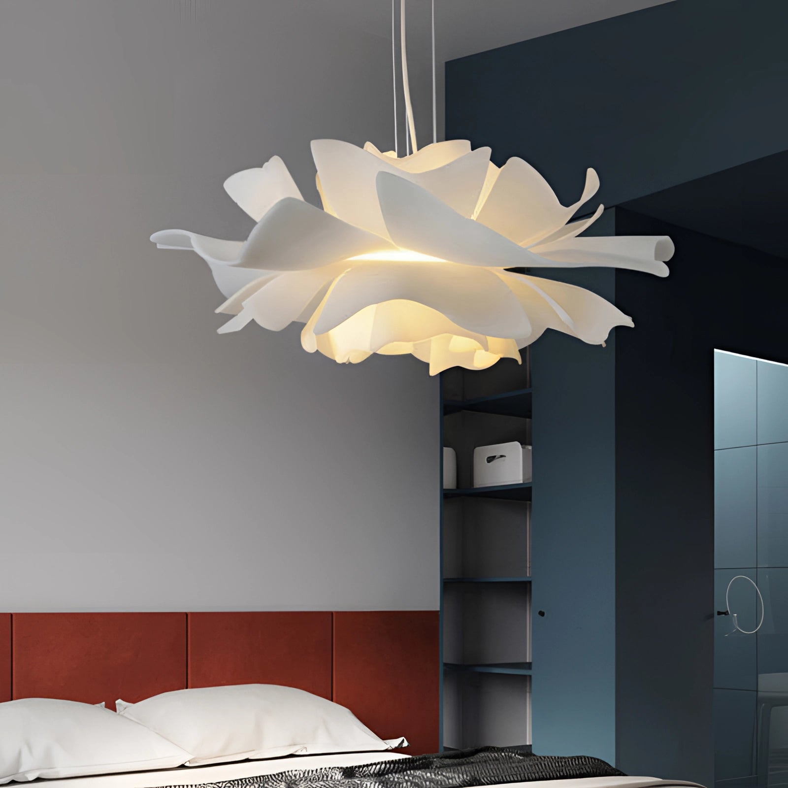 Modern flower-shaped pendant light hanging in a stylishly designed interior space, showcasing a unique floral chandelier with intricate detailing and warm lighting.