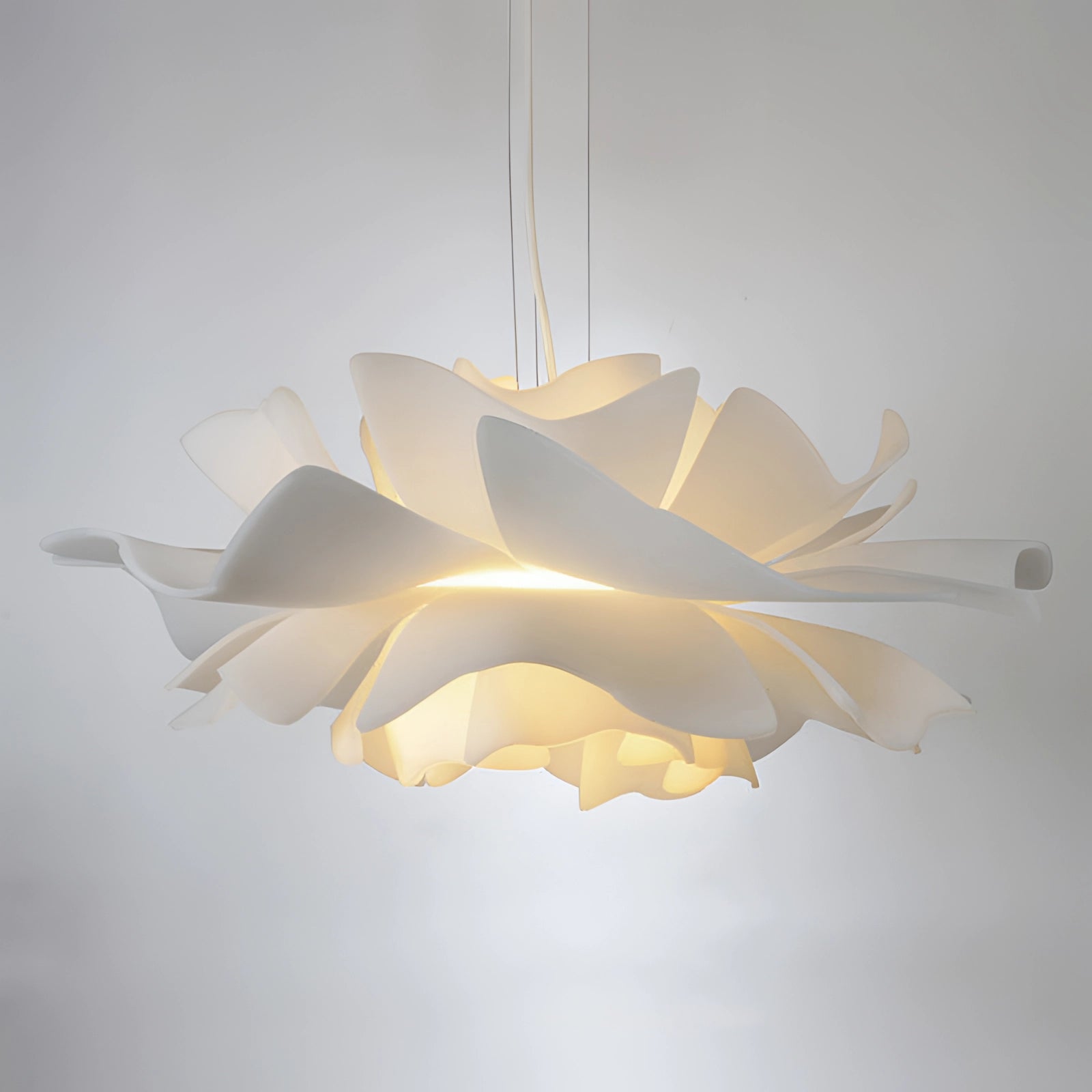 Modern flower-shaped pendant light with petal-like design, featuring an artistic and stylish floral chandelier hanging from the ceiling.