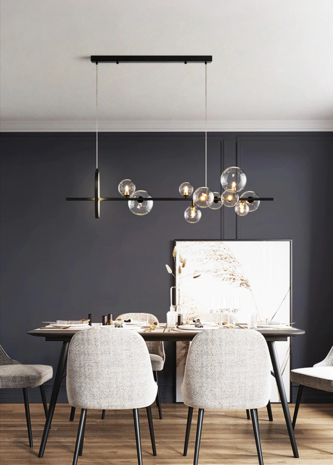 Modern geometric brass and glass chandelier hanging in a stylish interior with wooden table and chairs, grey flooring, and contemporary design elements.
