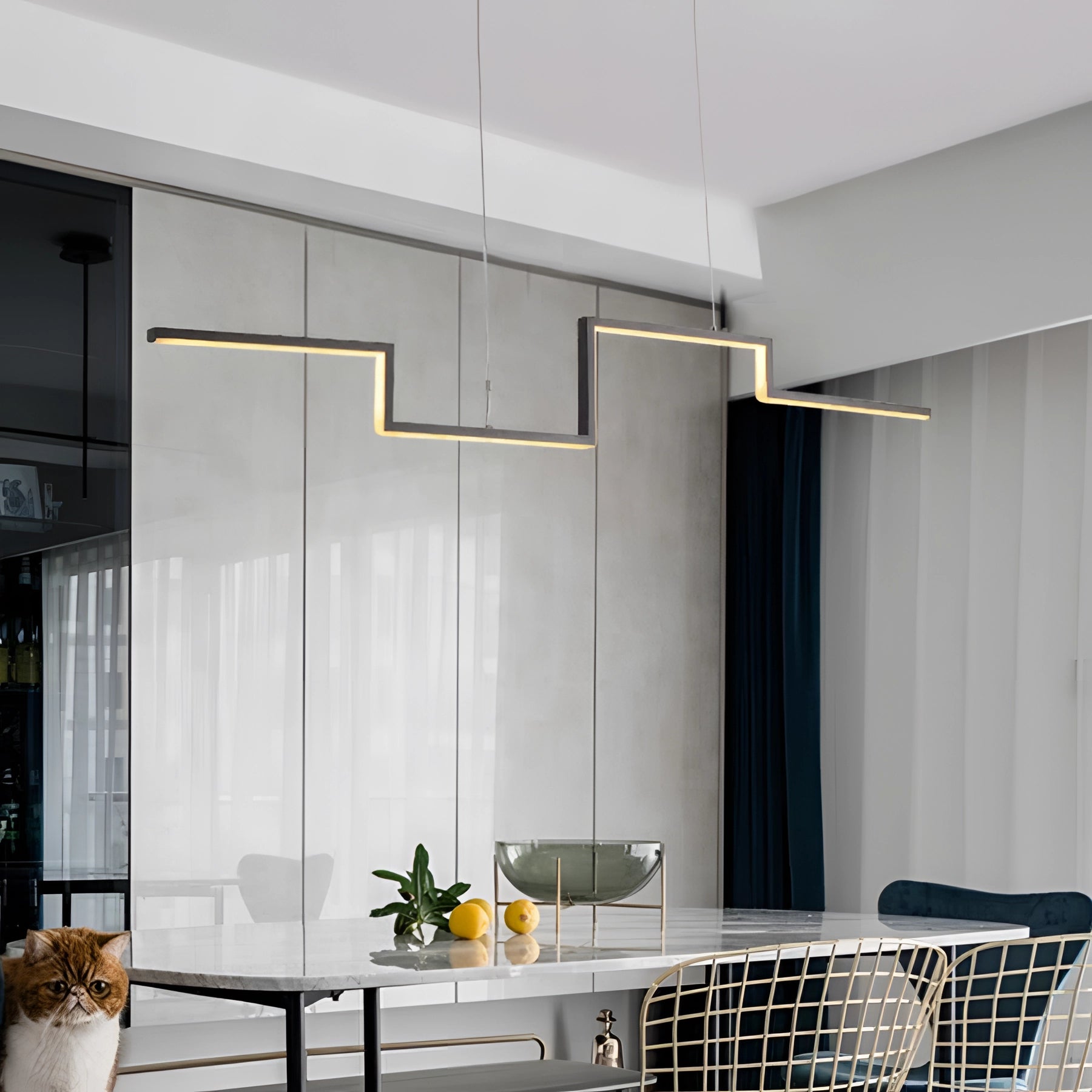 Modern geometric chandelier with luxury LED pendant light, dimmable feature, hanging over a wooden table in a stylishly designed interior space with large windows, plants, and contemporary furniture elements.