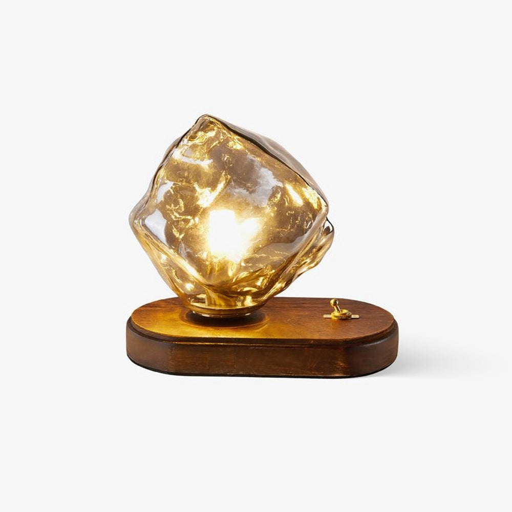 Modern geometric glass desk lamp with a wooden base featuring an artistic light design.