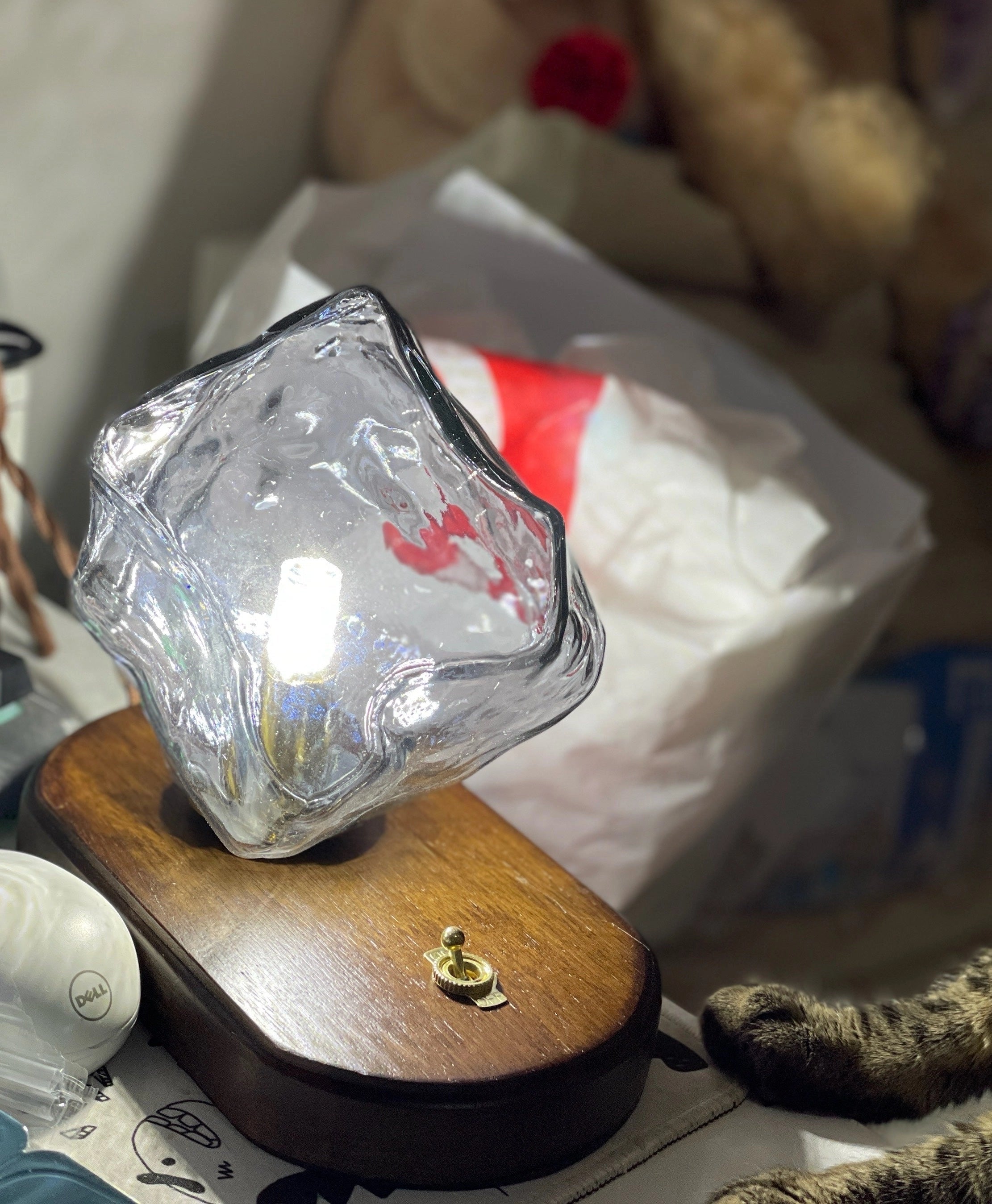 Modern geometric glass desk lamp with artistic light and wooden base, featuring a sleek and contemporary design.