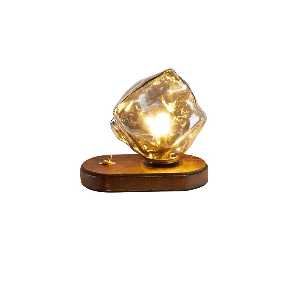 Modern geometric glass desk lamp with artistic light, wooden base, amber glow, and gold accents.