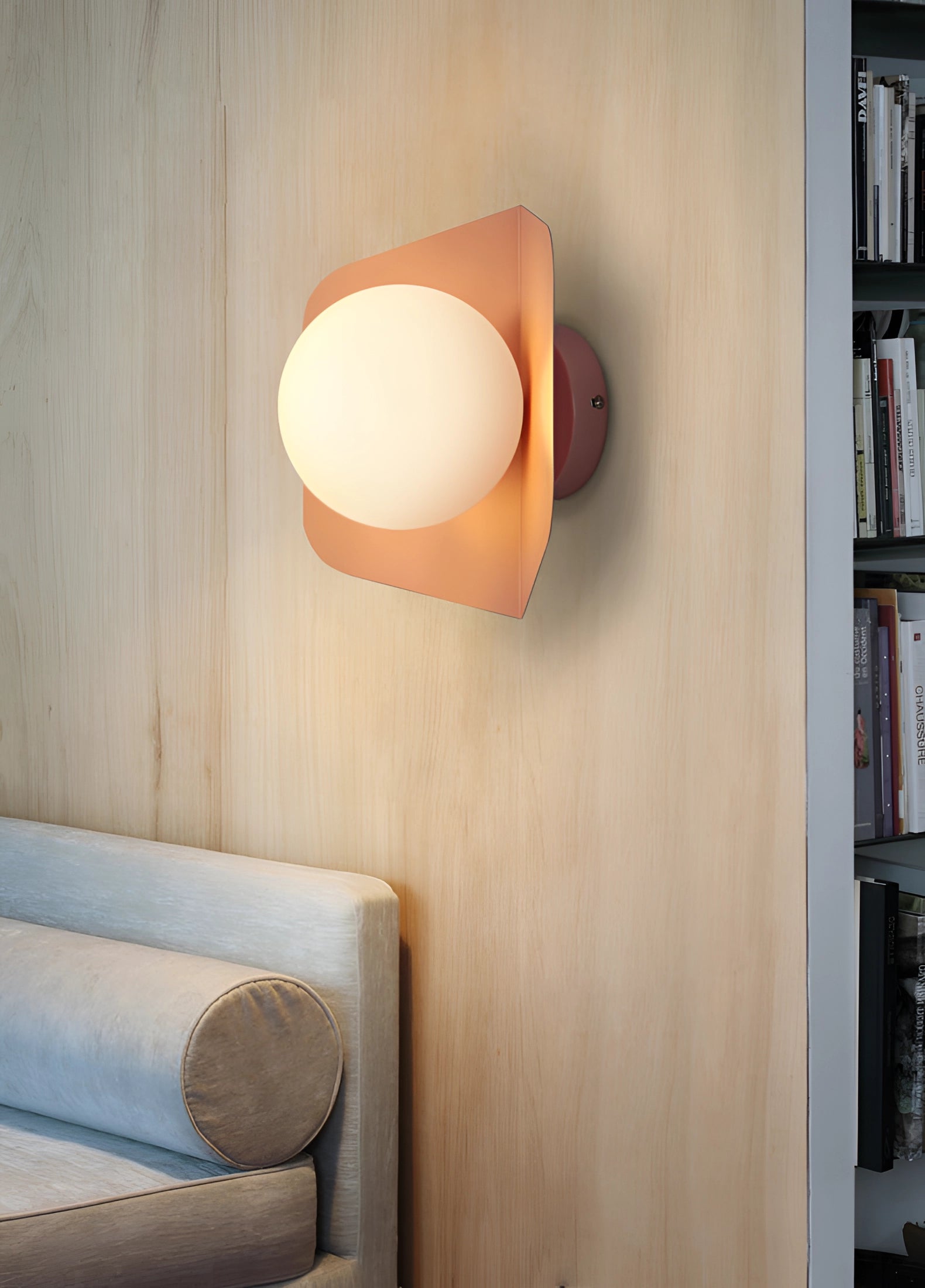 Modern geometric LED wall lamps with multi-color hexagonal fixtures mounted on a beige wall, integrated into a stylish interior design with wooden shelves and a bookcase.