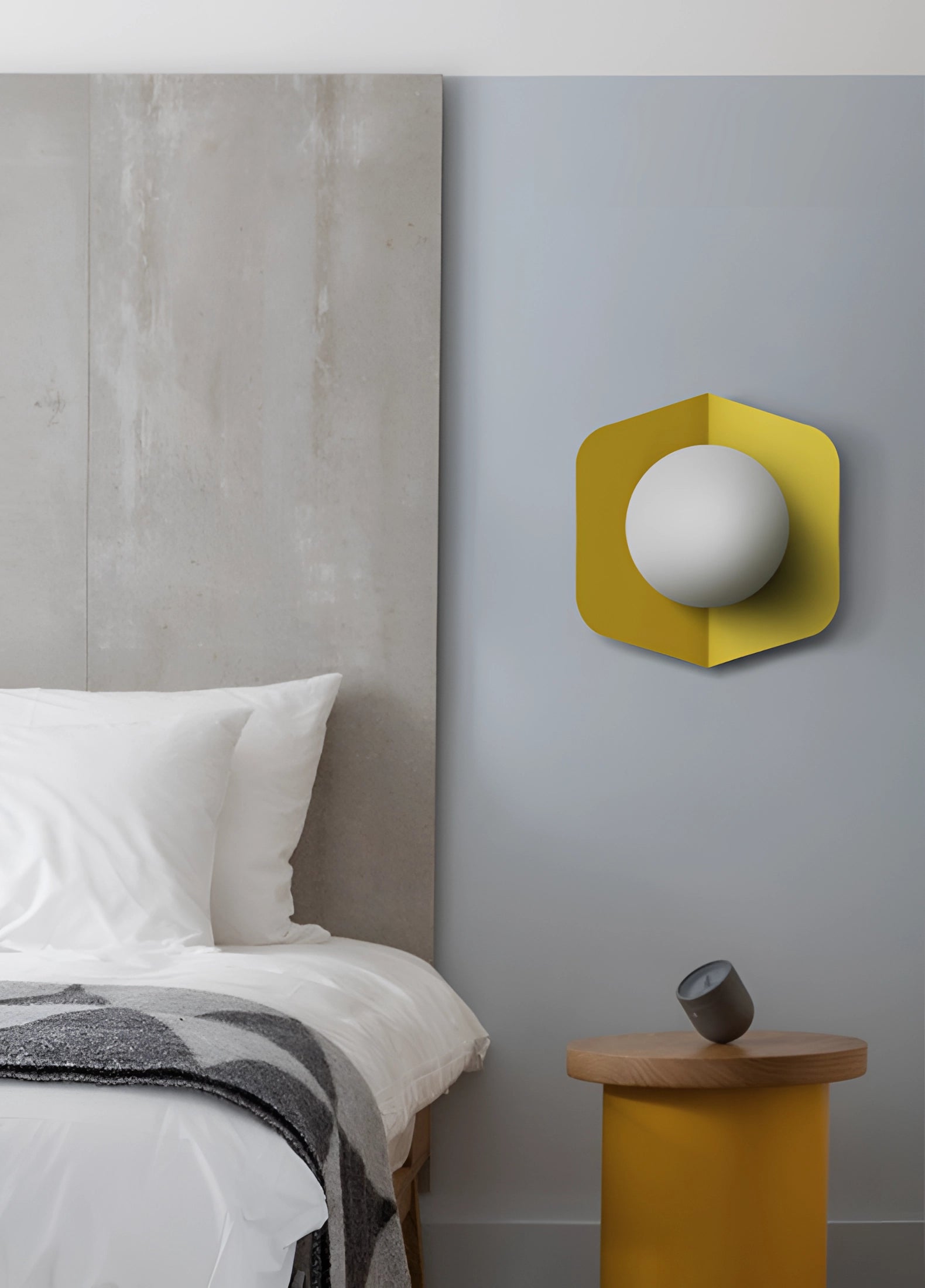 Modern geometric LED hexagonal wall lamps in a multi-color design, mounted on a grey wall in a comfortable, stylish interior with wooden elements and a grey floor.
