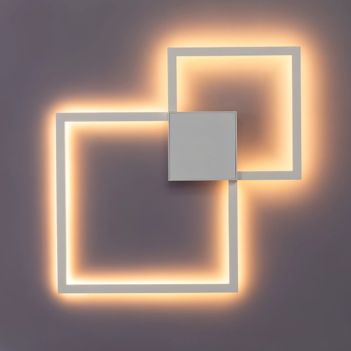 Modern geometric LED wall sconce in a sleek white finish, featuring a rectangular shape with a minimalist and symmetrical design, providing energy-efficient lighting.