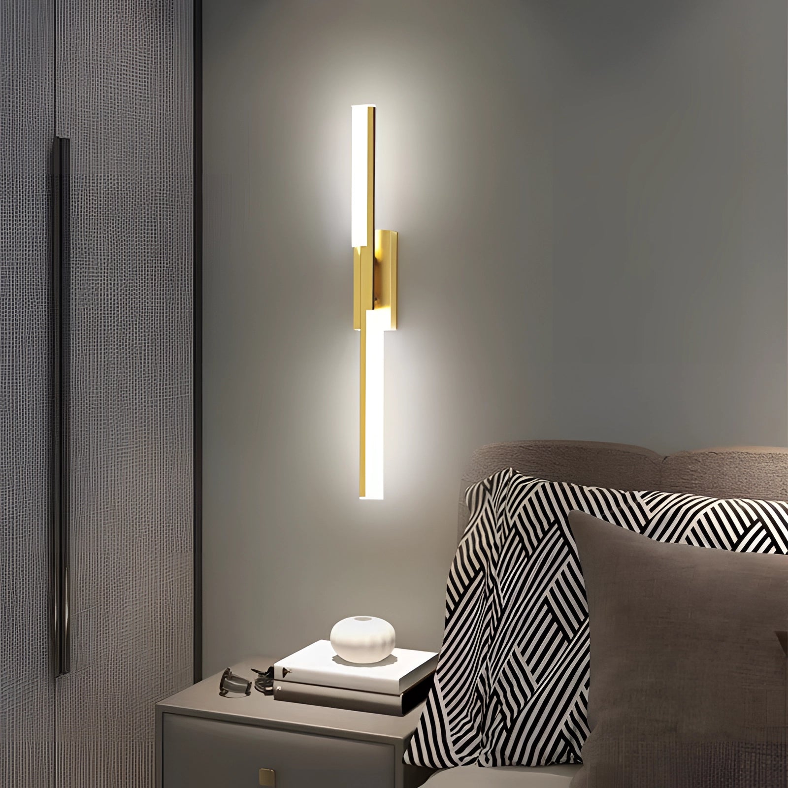 Modern geometric LED wall sconce with a minimalist design in black and white, featuring a 23.6-inch gold frame that allows for three color changes controlled by a switch, mounted on a wall in an interior setting.