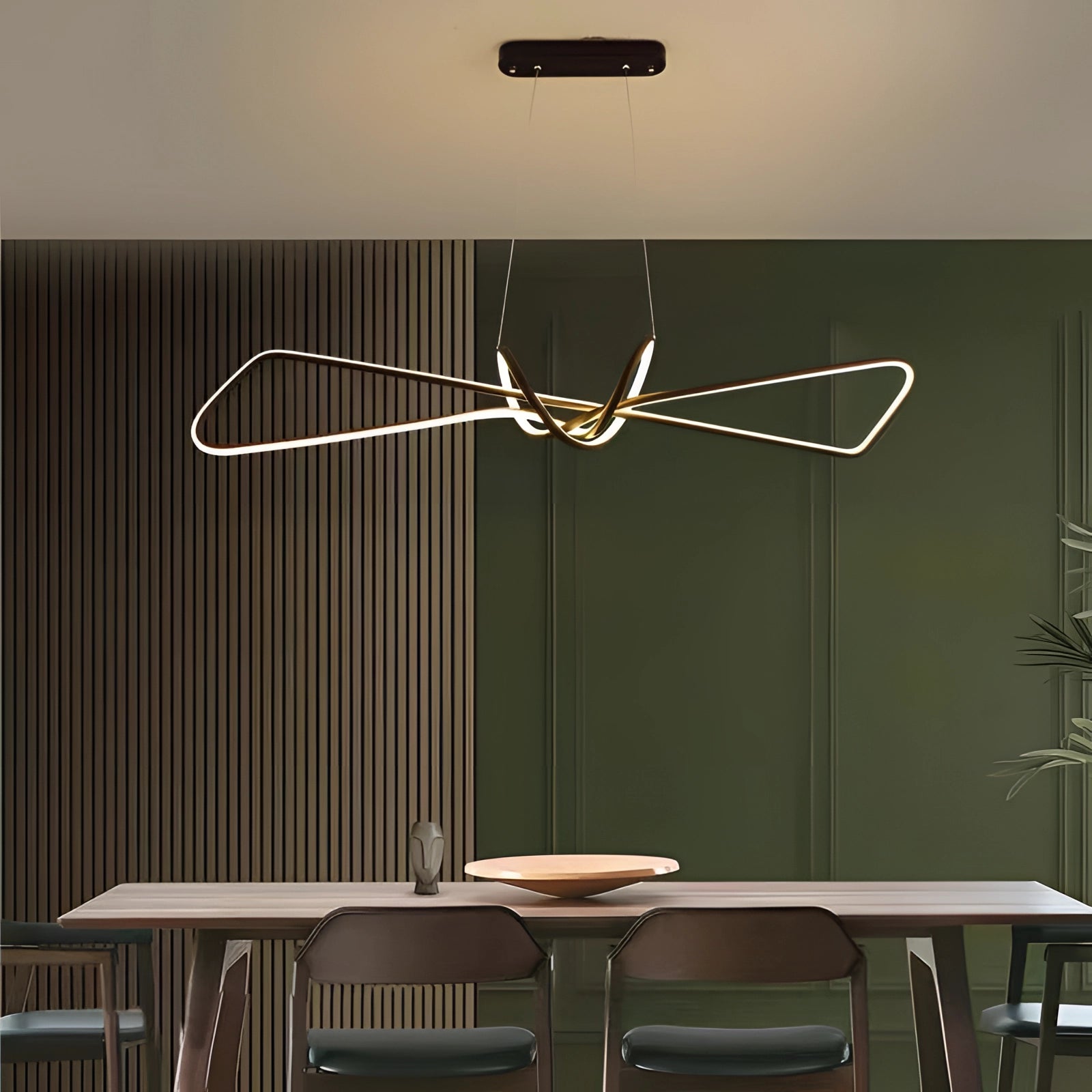 Modern geometric pendant light hanging from the ceiling in a minimalist interior setting with wooden furniture and flooring.