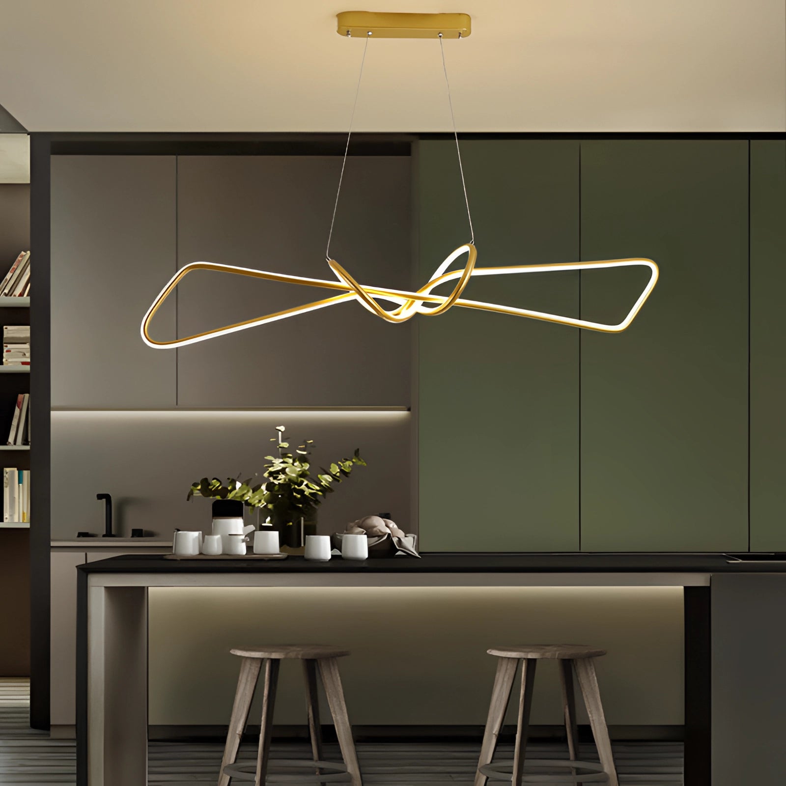 Modern geometric pendant light hanging in a minimalist interior setting, featuring a sleek rectangular design with wood accents, illuminating a space furnished with a table, desk, and decorative plants.