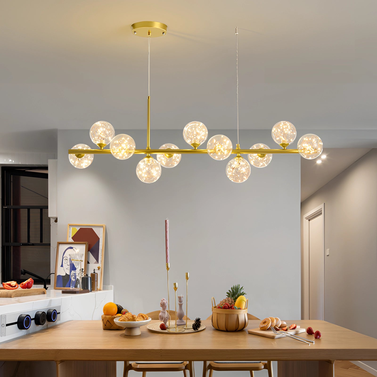 Modern glass globe chandelier with adjustable bronze pendant light illuminating a wooden table in a well-decorated interior space.