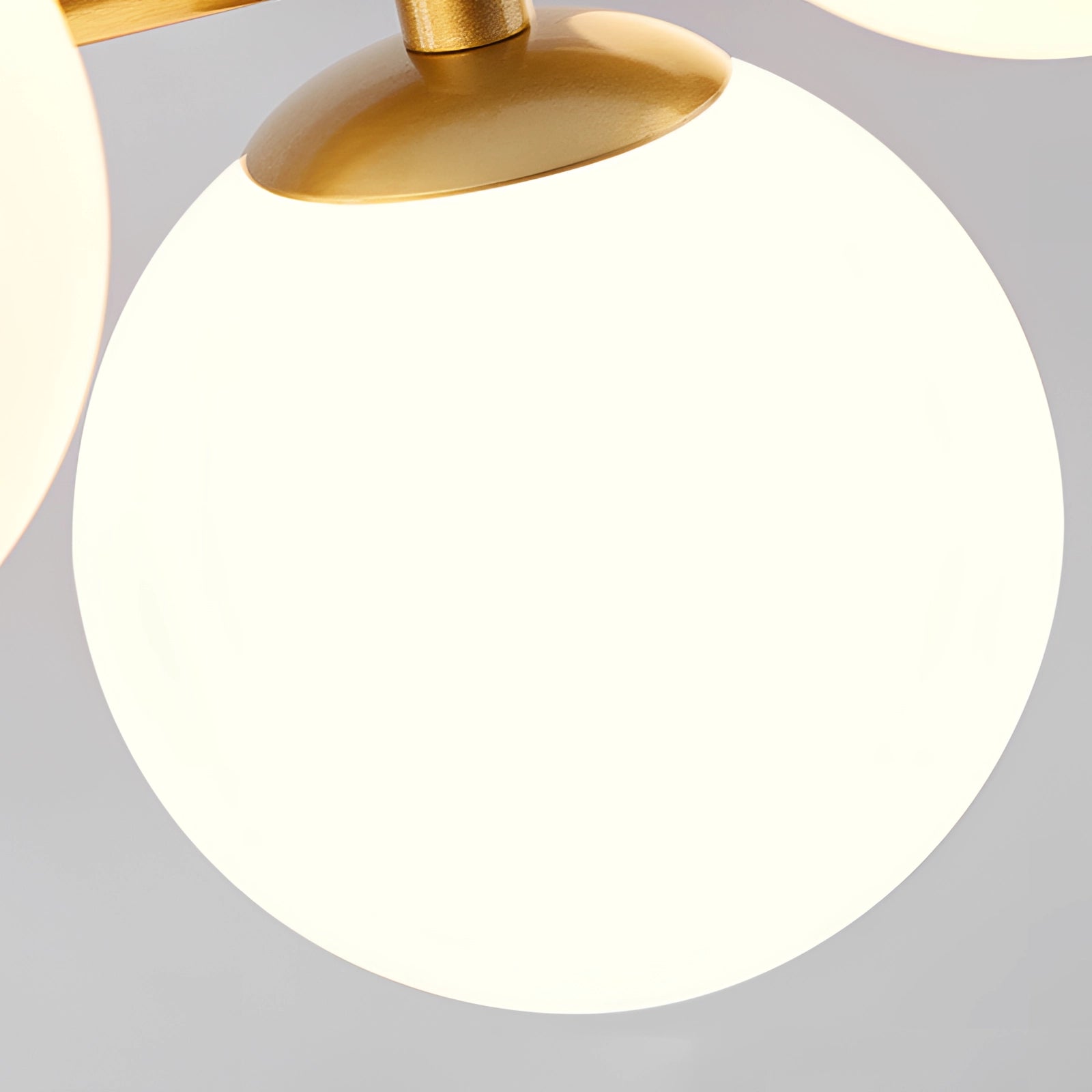 Modern glass globe chandelier with adjustable bronze pendant light hanging from a ceiling.