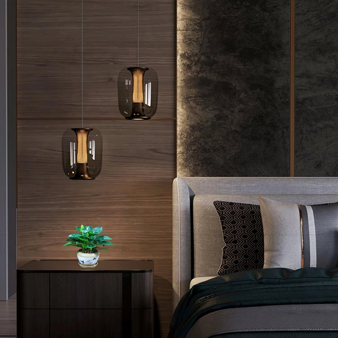 Modern glass LED pendant light with a sleek, minimalist design, featuring a rectangular shape and wood accents, illuminating a stylish bedroom interior.