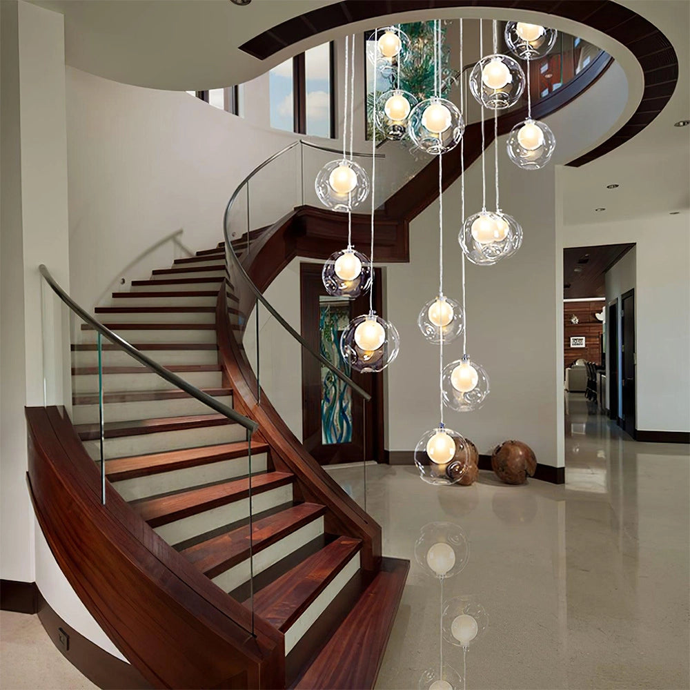 Modern globe pendant chandelier with adjustable LED lights hanging from a square ceiling plate, featuring 11 lights and illuminating a contemporary interior space with wooden flooring and baluster details.