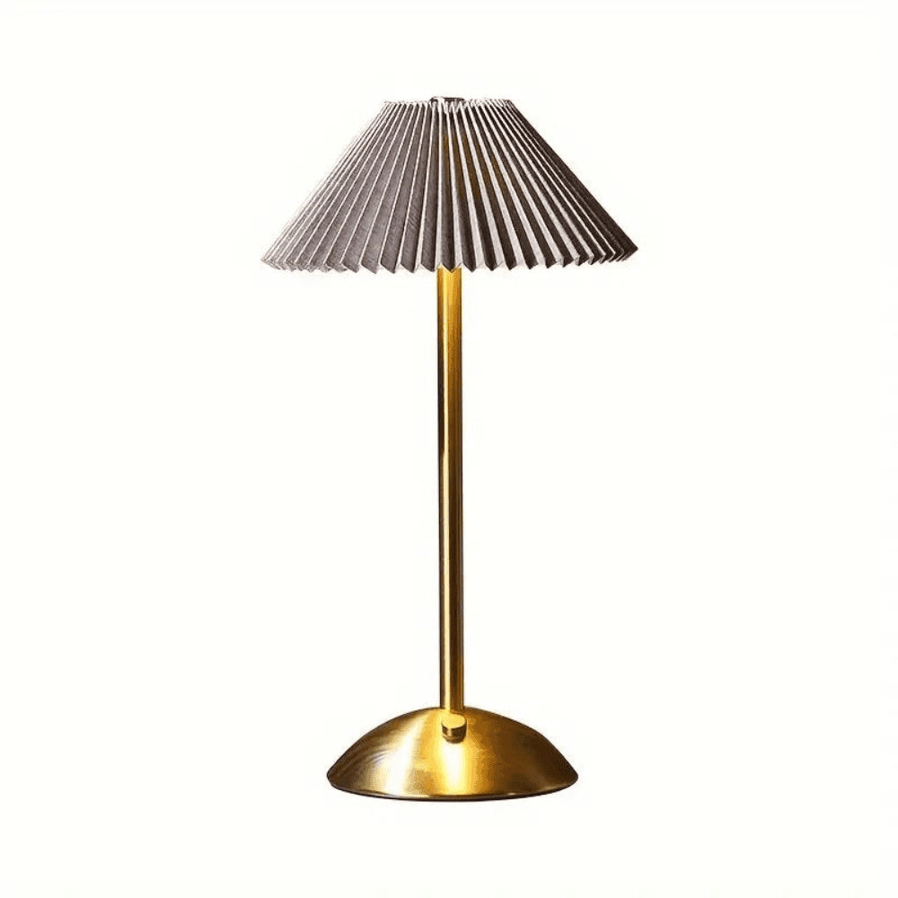 A modern table lamp featuring a gold base with an elegant ribbed pleated lampshade, combining contemporary design with timeless style.