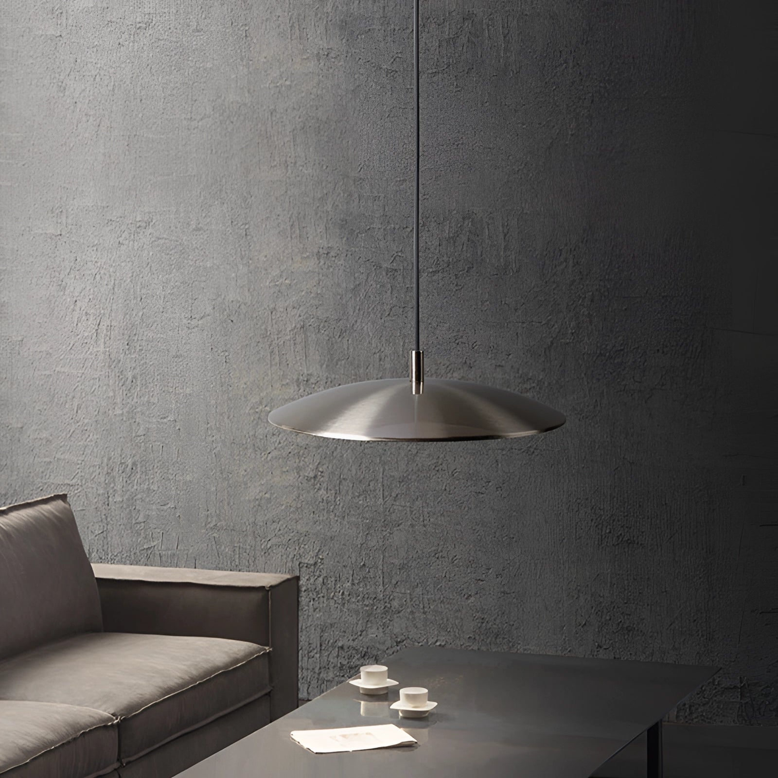 Modern gold-brushed pendant light fixture with a sleek design, hanging over a rectangular wooden dining table, adding an elegant and contemporary touch to the dining or kitchen area.