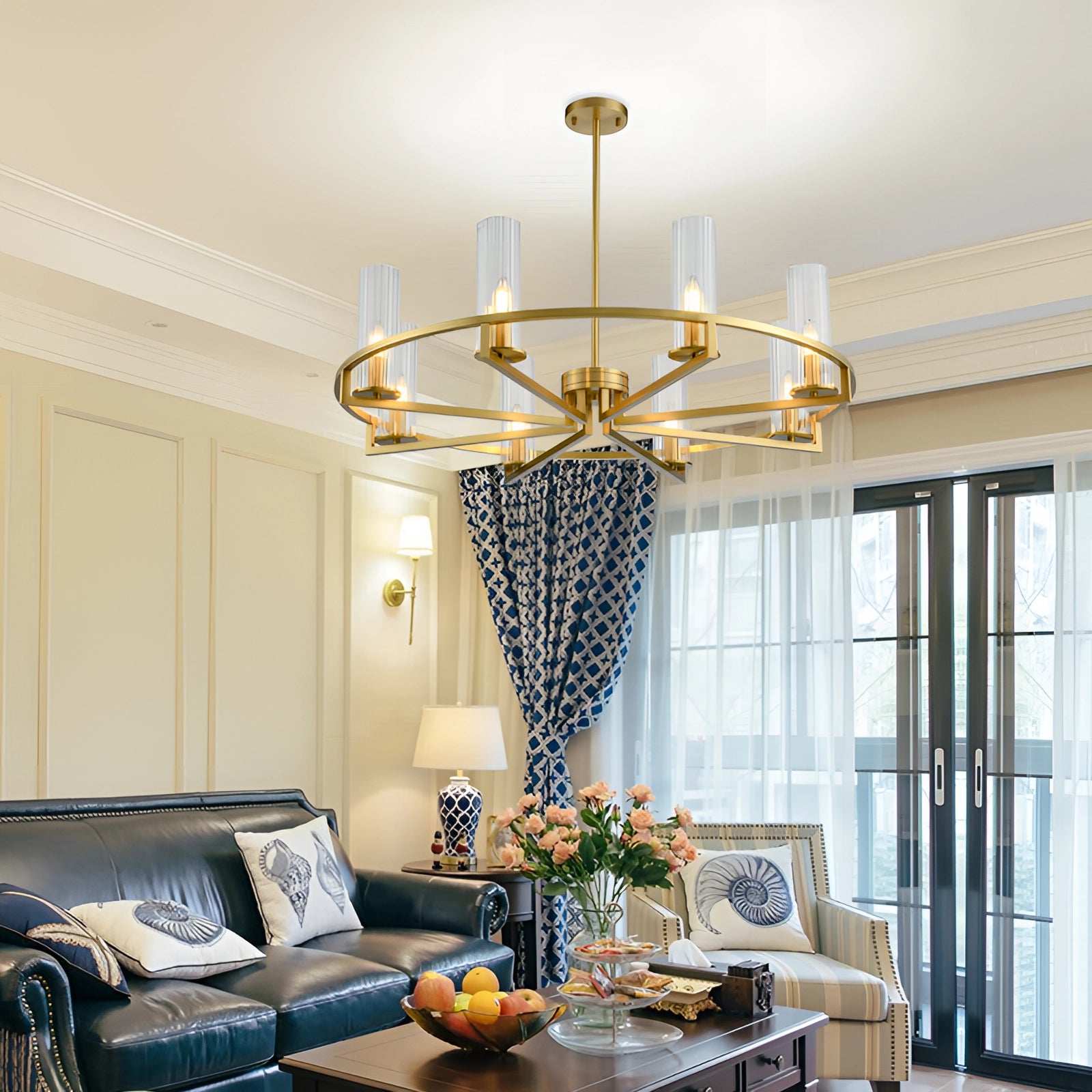 Modern gold chandelier with cylindrical glass shades, featuring eight lights, elegantly hanging above a wooden table and couch in a stylish living room setting.