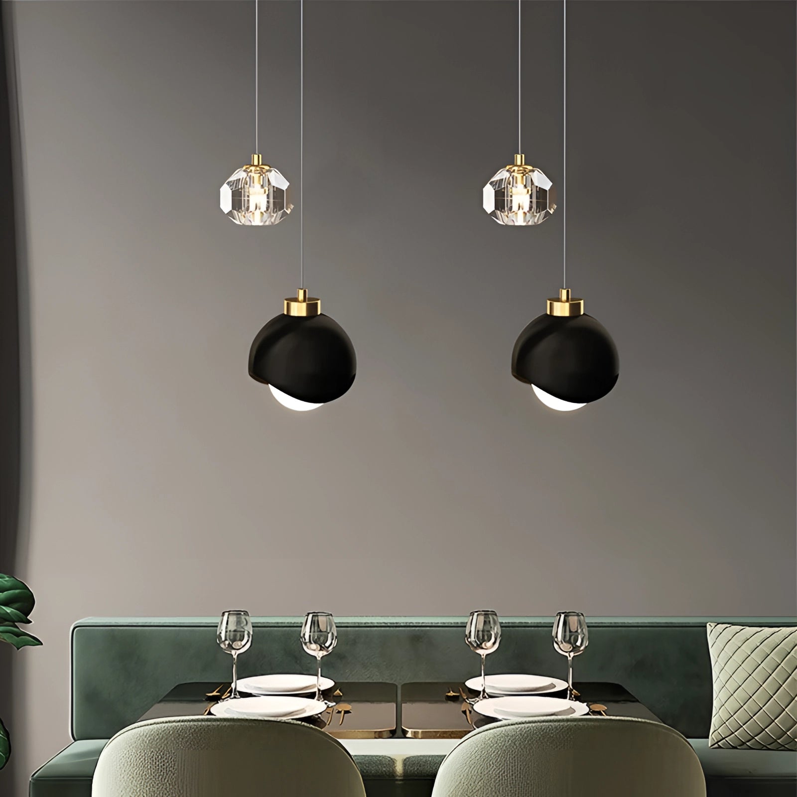 Modern gold dual pendant light hanging from the ceiling, featuring an adjustable design, illuminating a contemporary interior space with a table, chair, and houseplant underneath.
