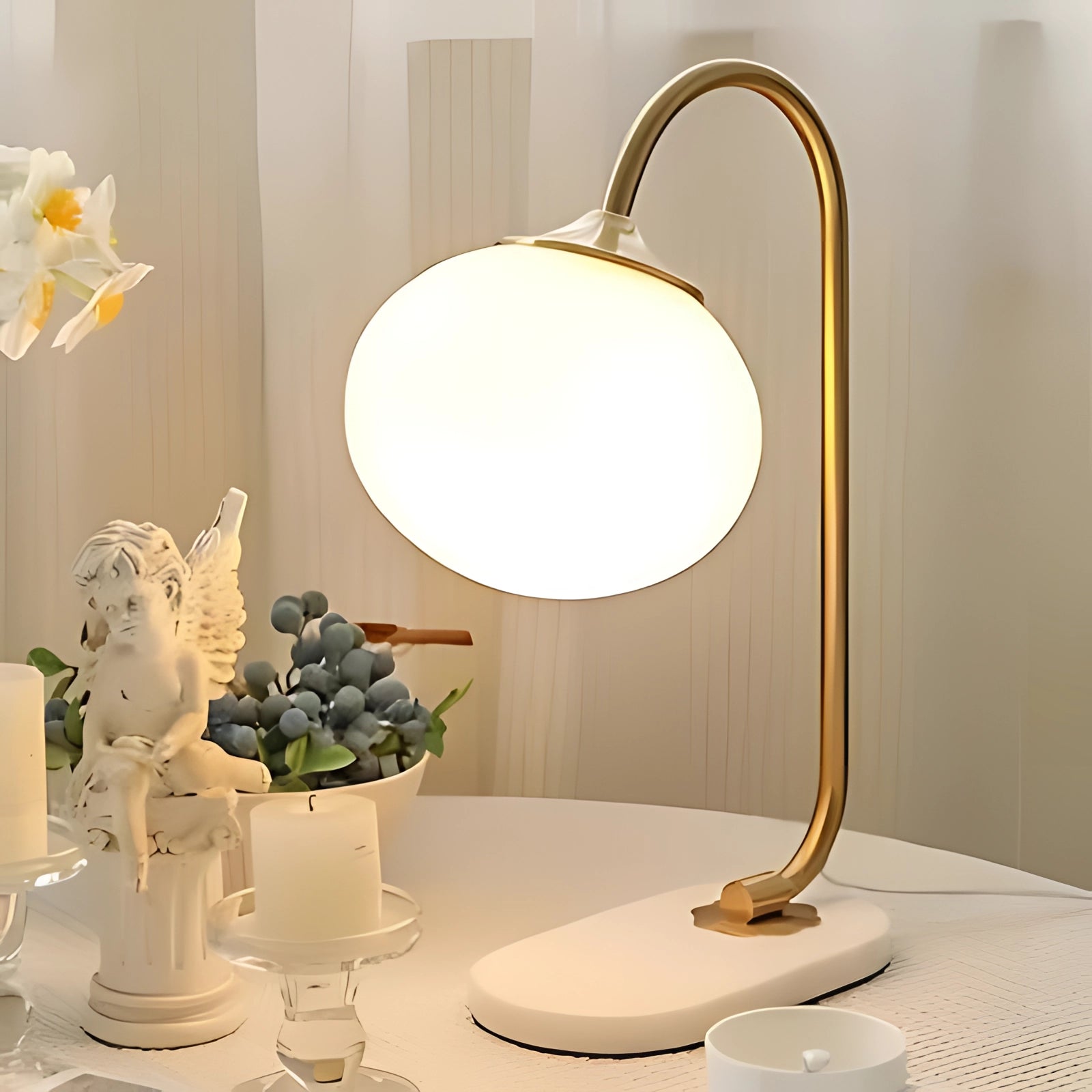 Modern gold finish table lamp with a minimalist curved design in a gold yellow color, placed on a reflective surface. The lamp is elegantly styled within a contemporary interior setting, highlighting its sleek and sophisticated appearance.