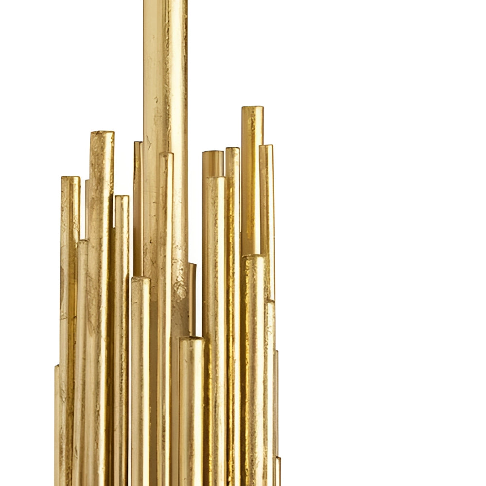 Modern gold floor lamp with a white shade featuring elegant vertical rods, displayed in a living room setting with a plant in the background.