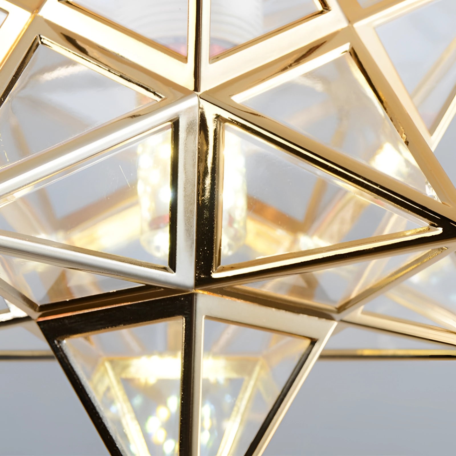 Modern gold geometric star ceiling light pendant lamp featuring a symmetrical design with interconnected triangular shapes and a luxurious finish.