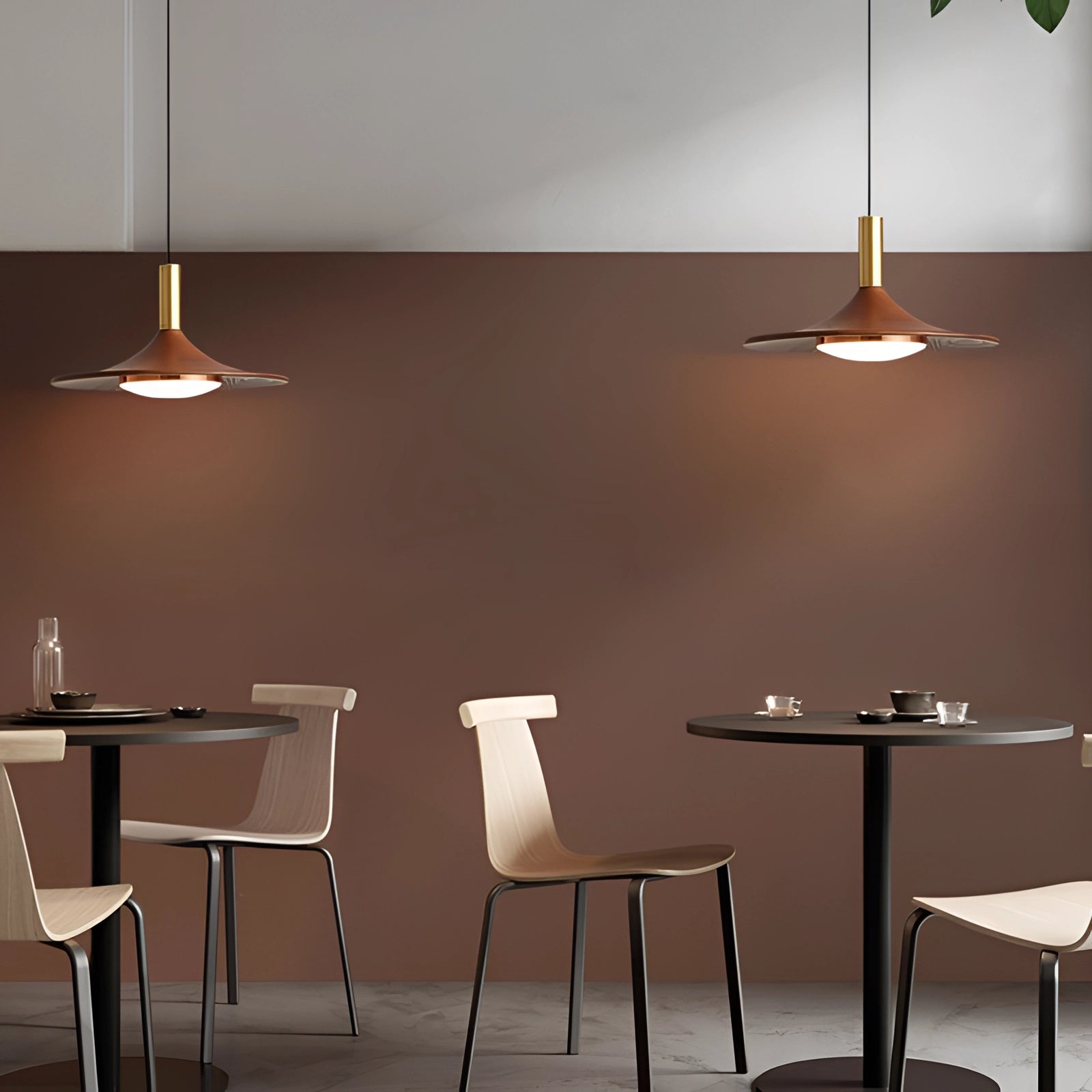 Modern gold LED pendant light with a sleek Scandinavian design, featuring a 14-inch fixture with two lights and third gear dimming, illuminating a stylish interior with furniture including a wooden table and chair.