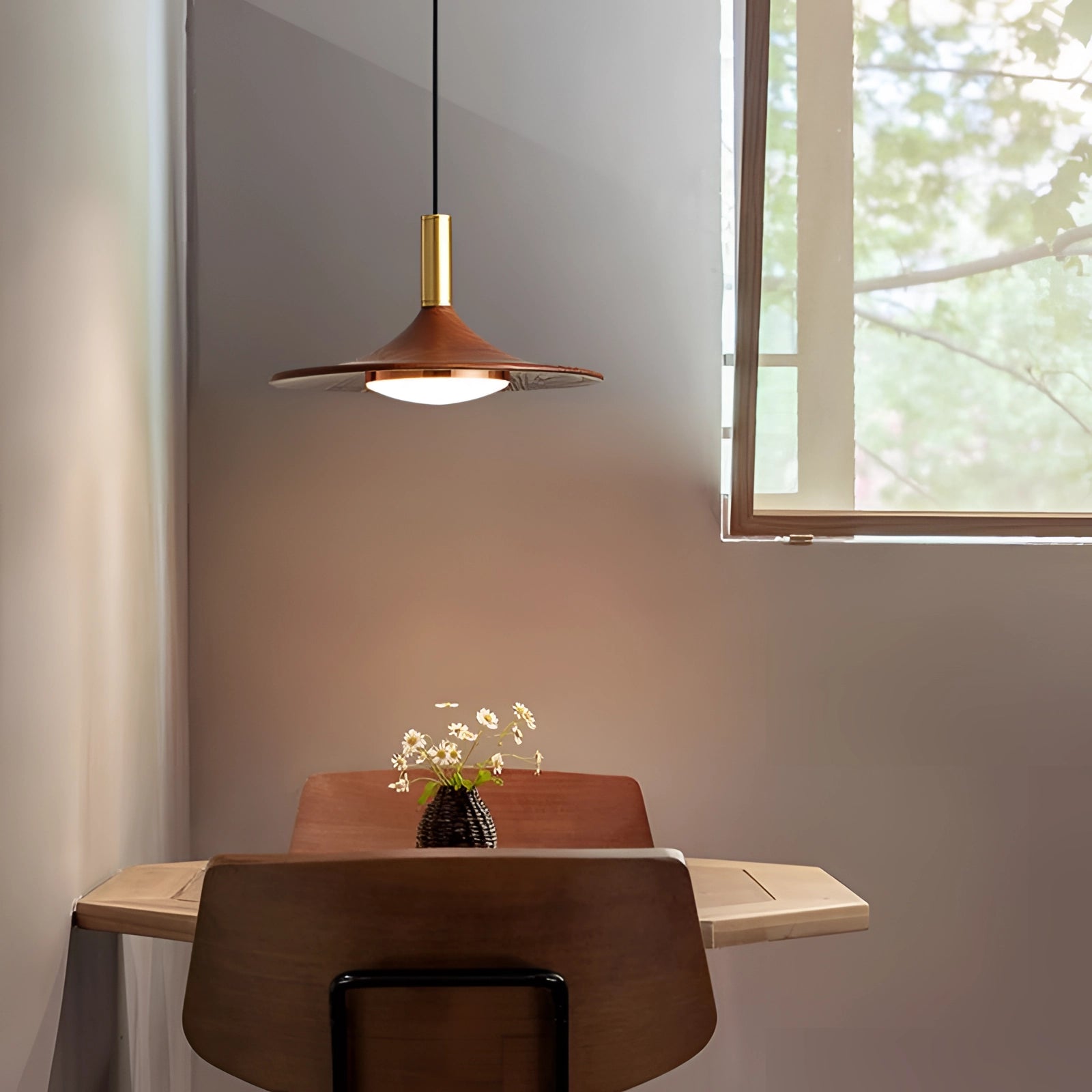 Modern gold LED pendant light fixture with Scandinavian design, featuring a 14-inch single light with third gear dimming capabilities, hanging above a wooden table in a stylish interior setting, next to a window.