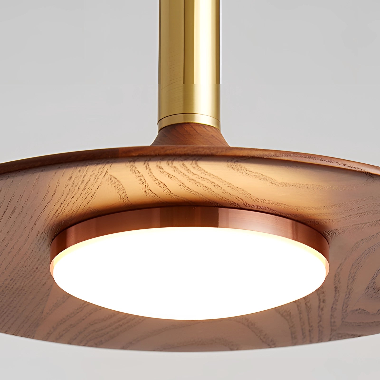 Modern gold LED pendant light with a Scandinavian design, featuring an oval and rectangular shape with a beige and wooden finish, hanging from the ceiling.