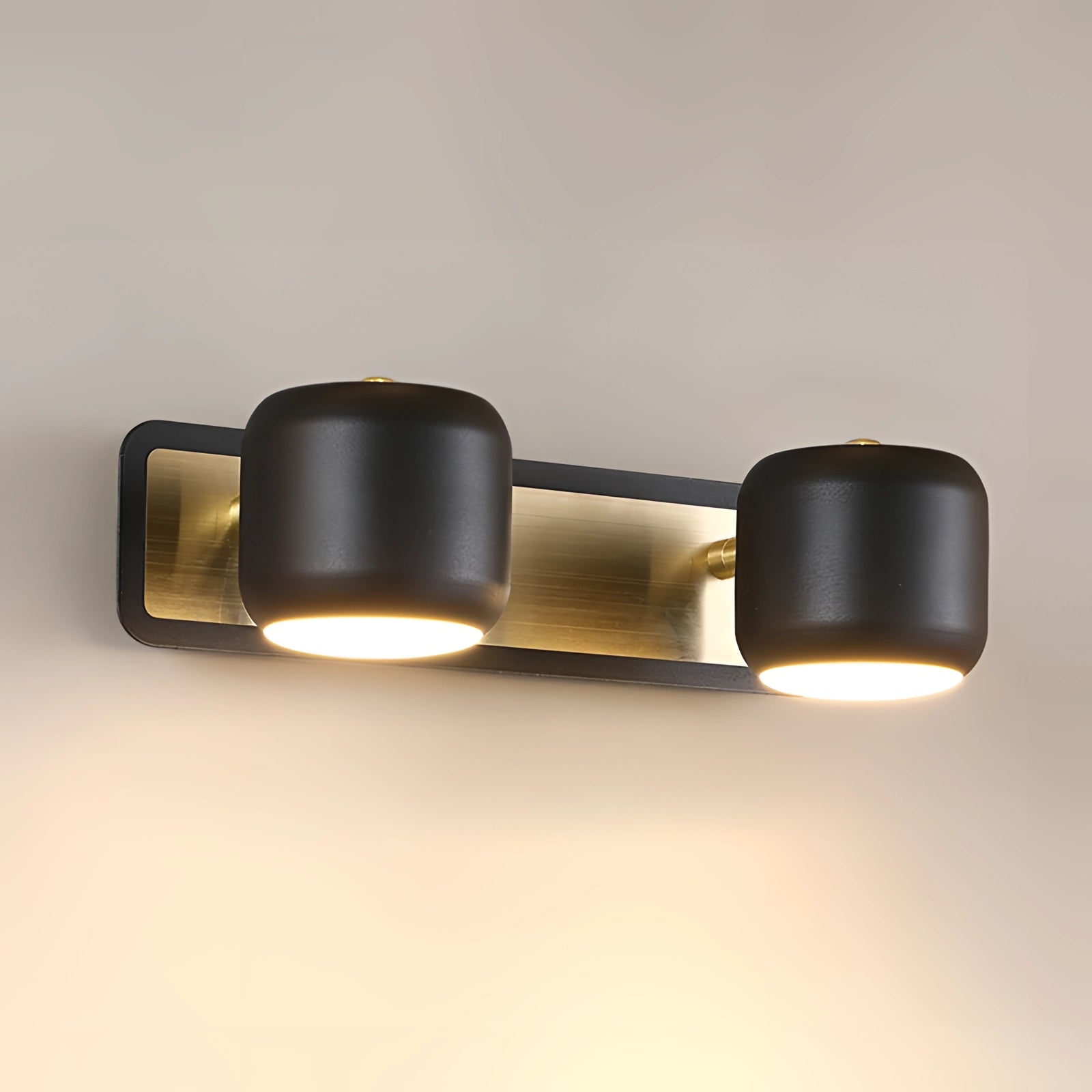 
A sleek black and gold modern LED vanity light fixture featuring a minimalist design with two cylindrical lights, suitable for bathroom installation.