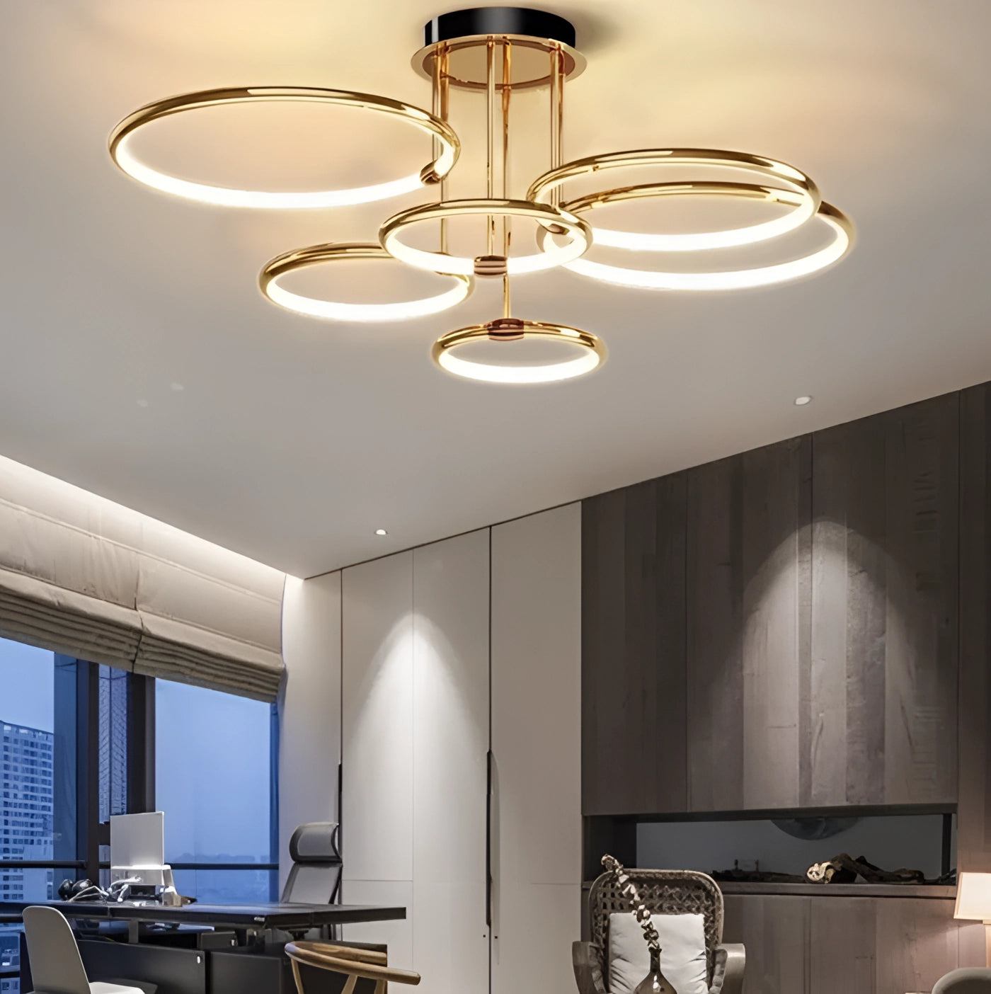 A modern gold ring LED chandelier with adjustable circular pendant light hanging from the ceiling in a stylish living room with wooden furniture and contemporary interior design.