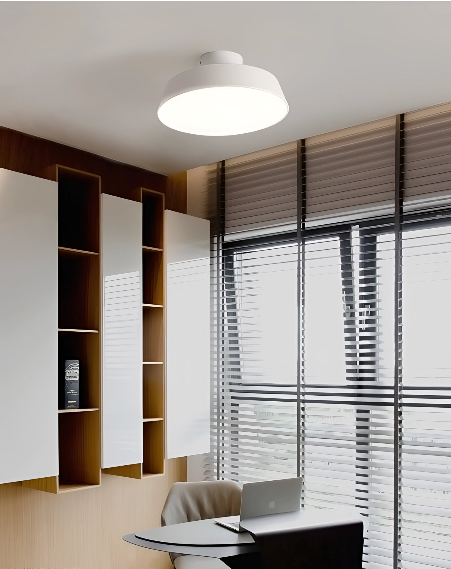 Modern grey LED pendant light with minimalist industrial design, featuring a wooden accent, hanging from the ceiling over a table in a stylish interior setting.