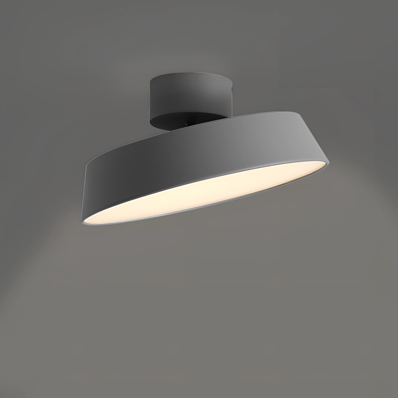 Modern grey LED pendant light with minimalist industrial design, featuring a cylindrical shape and a light bulb, hanging from the ceiling.