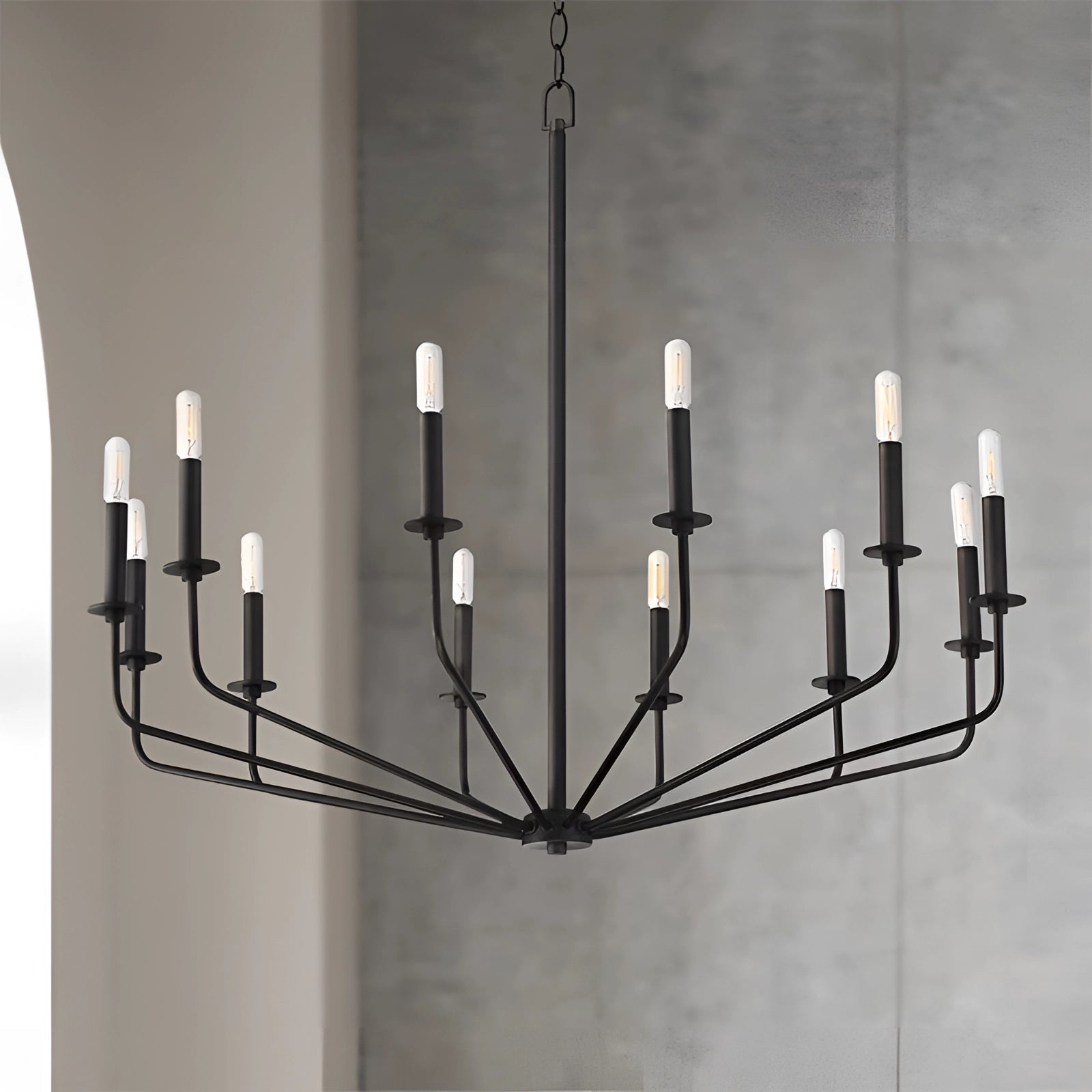 Modern industrial 12-light black chandelier with an adjustable chain, featuring a symmetrical design and metal construction, hanging from a ceiling.