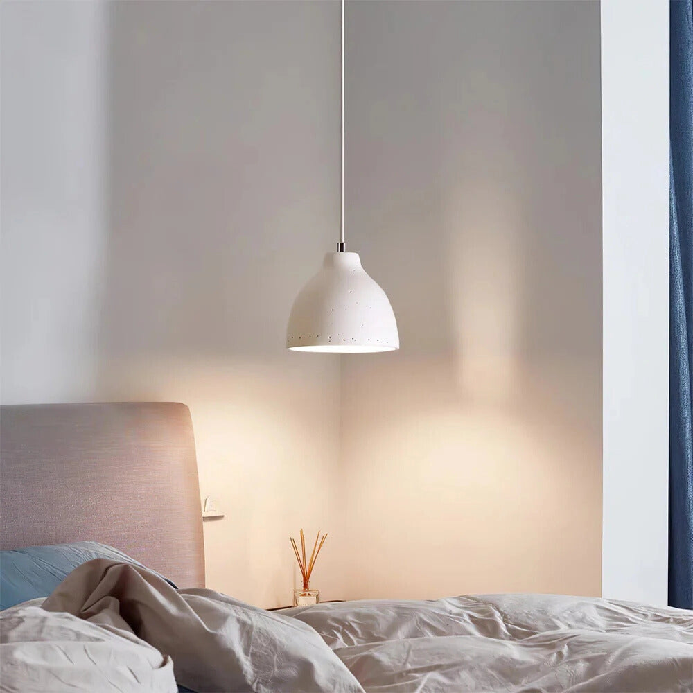 A modern industrial concrete pendant light with a Scandinavian yellow accent, featuring a white shade with a diameter of 11 inches, hanging in a stylish interior setting with wood and grey elements.