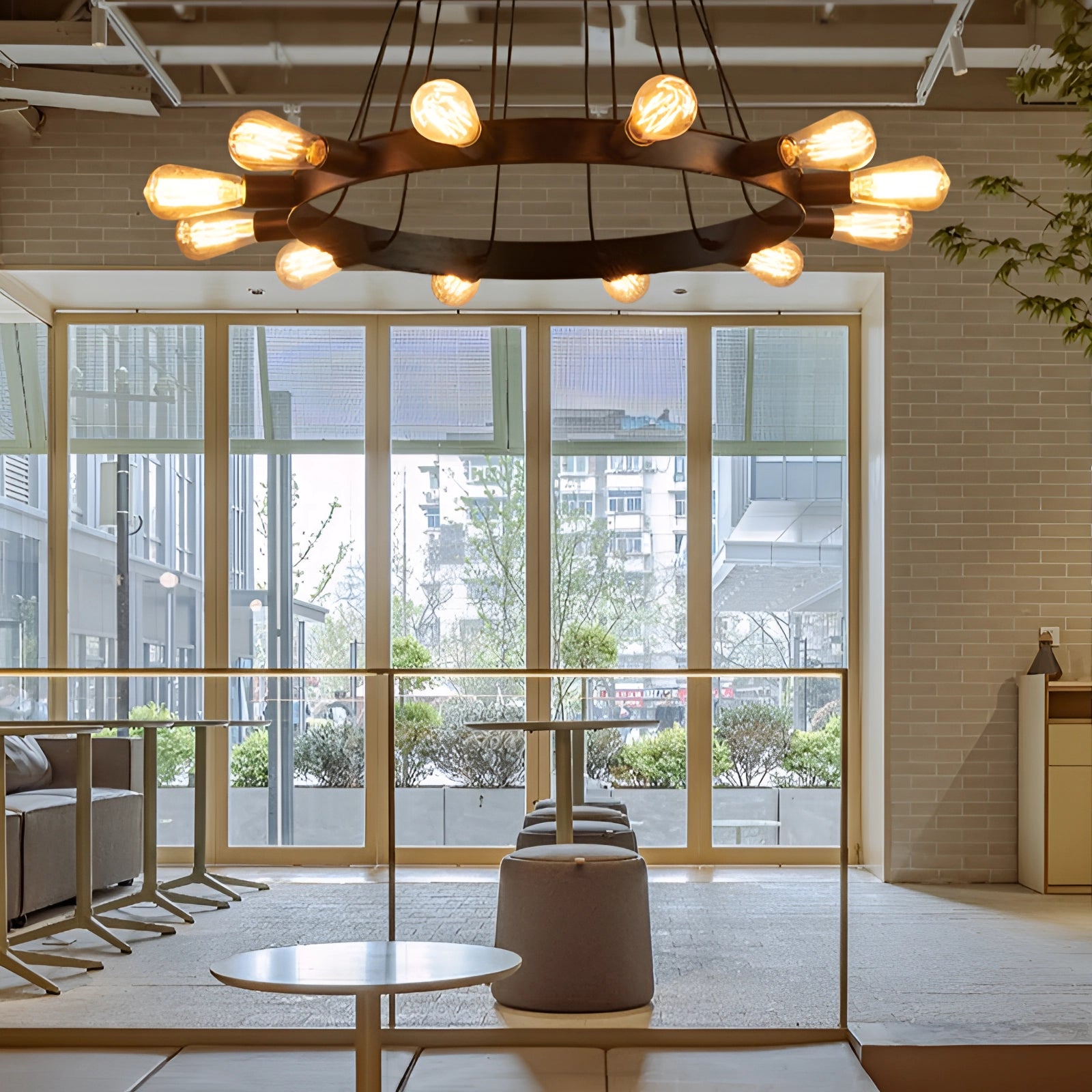 Circular modern industrial LED chandelier with a diameter of 33.5 inches, hanging in a stylish interior featuring wood elements, large windows, and contemporary design.