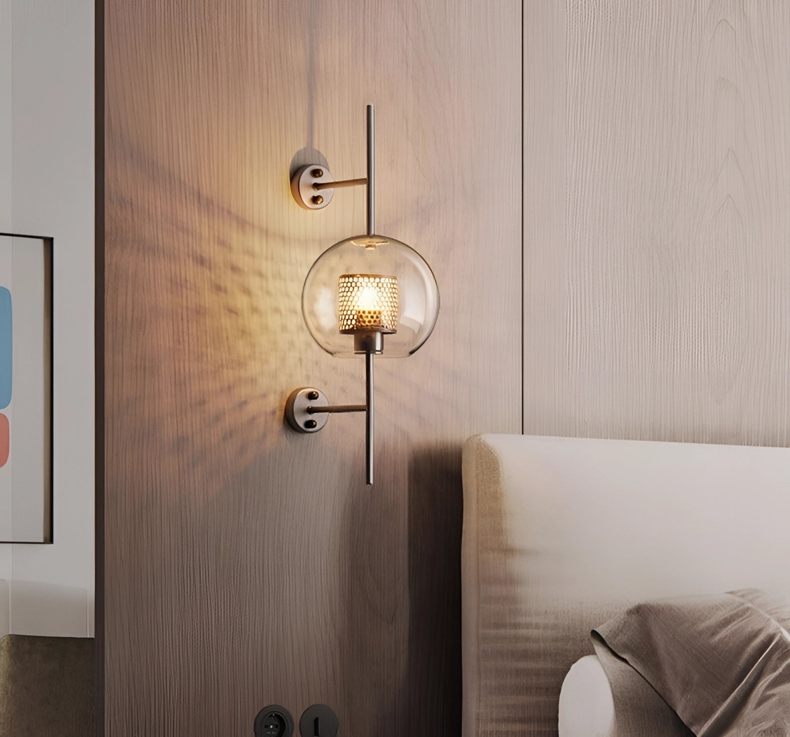 Modern industrial wall-mounted sconce with metal frame and glass shade, mounted on a wooden wall.