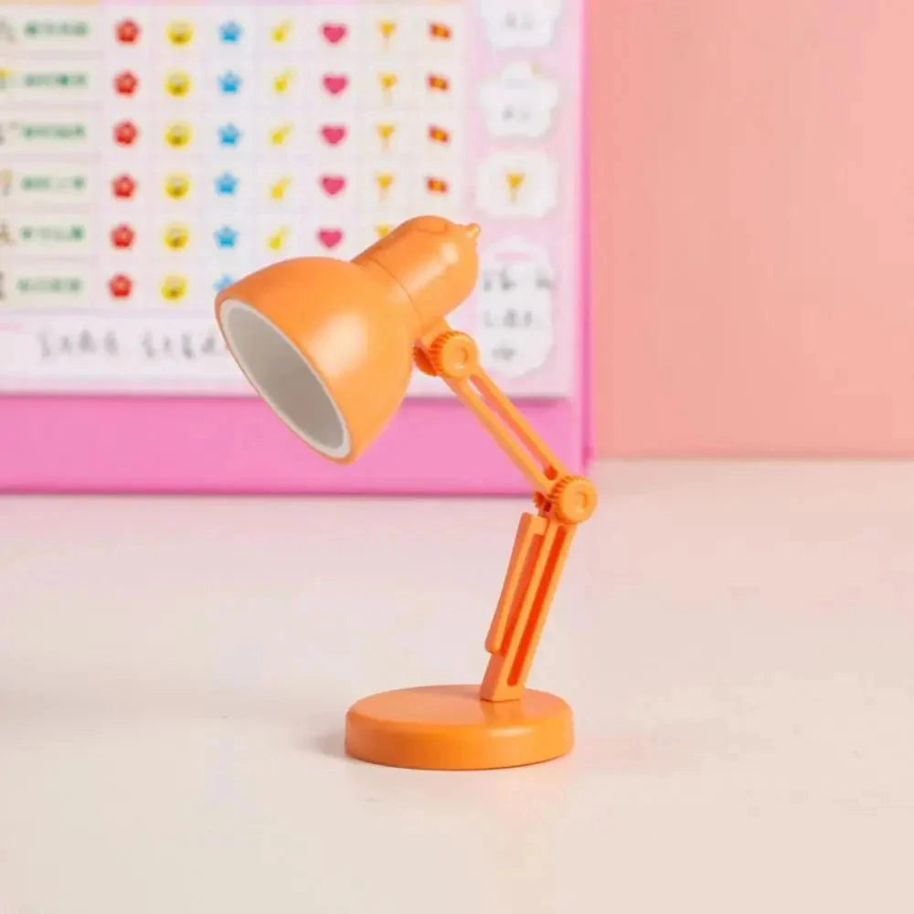 
A modern LED black desk lamp with an adjustable arm, featuring a minimalist and compact design, displayed on a wooden desk. The lamp is styled in an orange variant, blending with various office supplies and furniture around it.