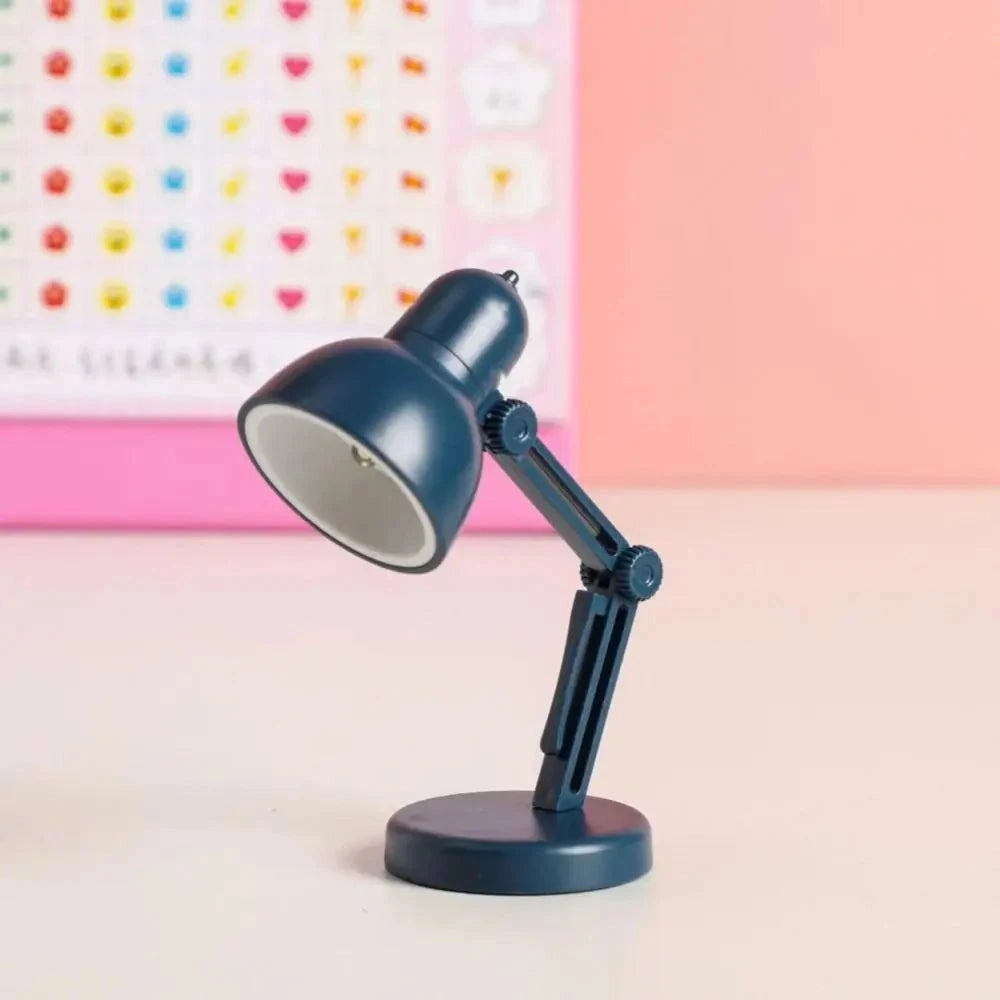 
A modern black desk lamp featuring a minimalist design with an adjustable arm, standing on a sleek blue base.